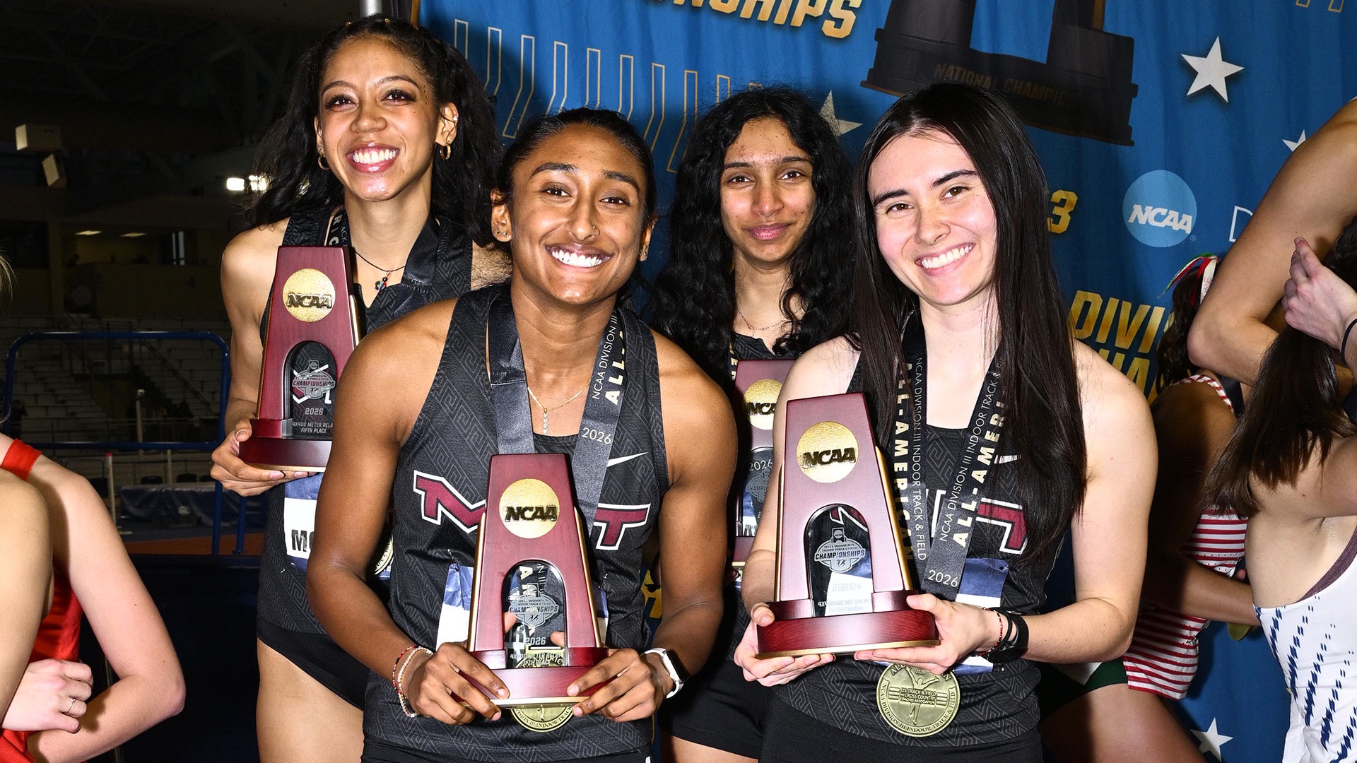 MIT 4 x 400m Relay team at the podium with trophies