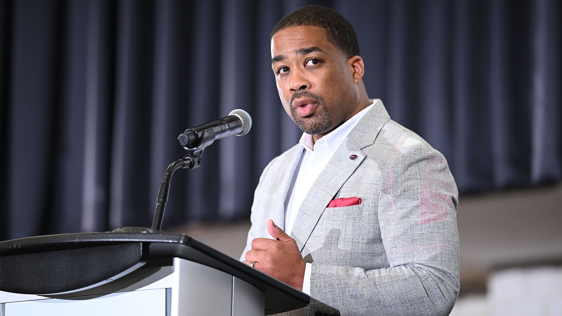 Anthony Grant speaking at the podium