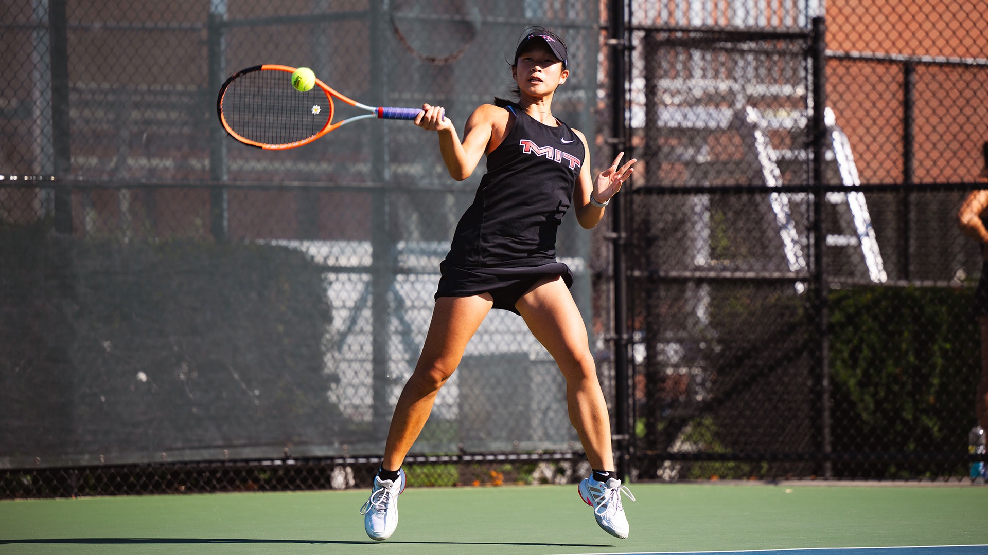 Rayna Li hitting the tennis ball with her racket