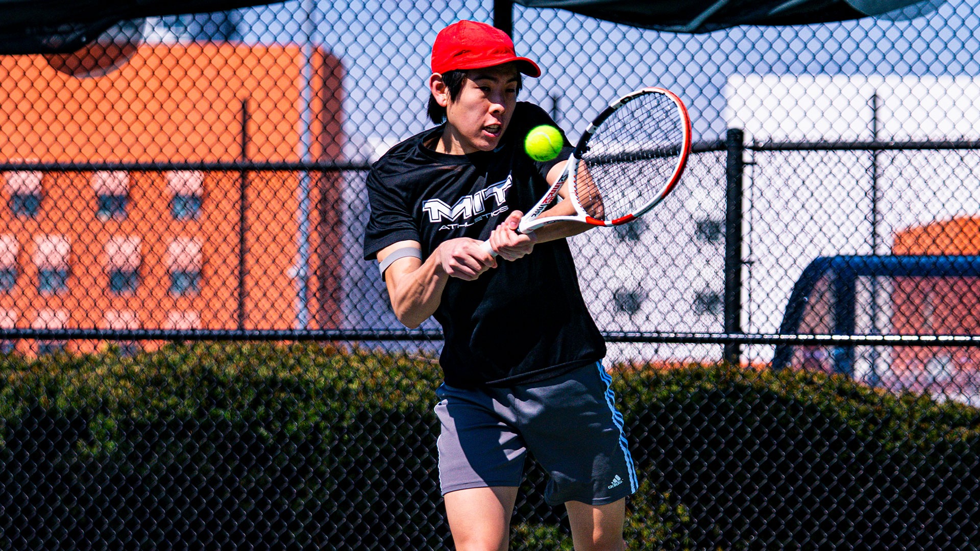 Men's tennis player hitting a shot