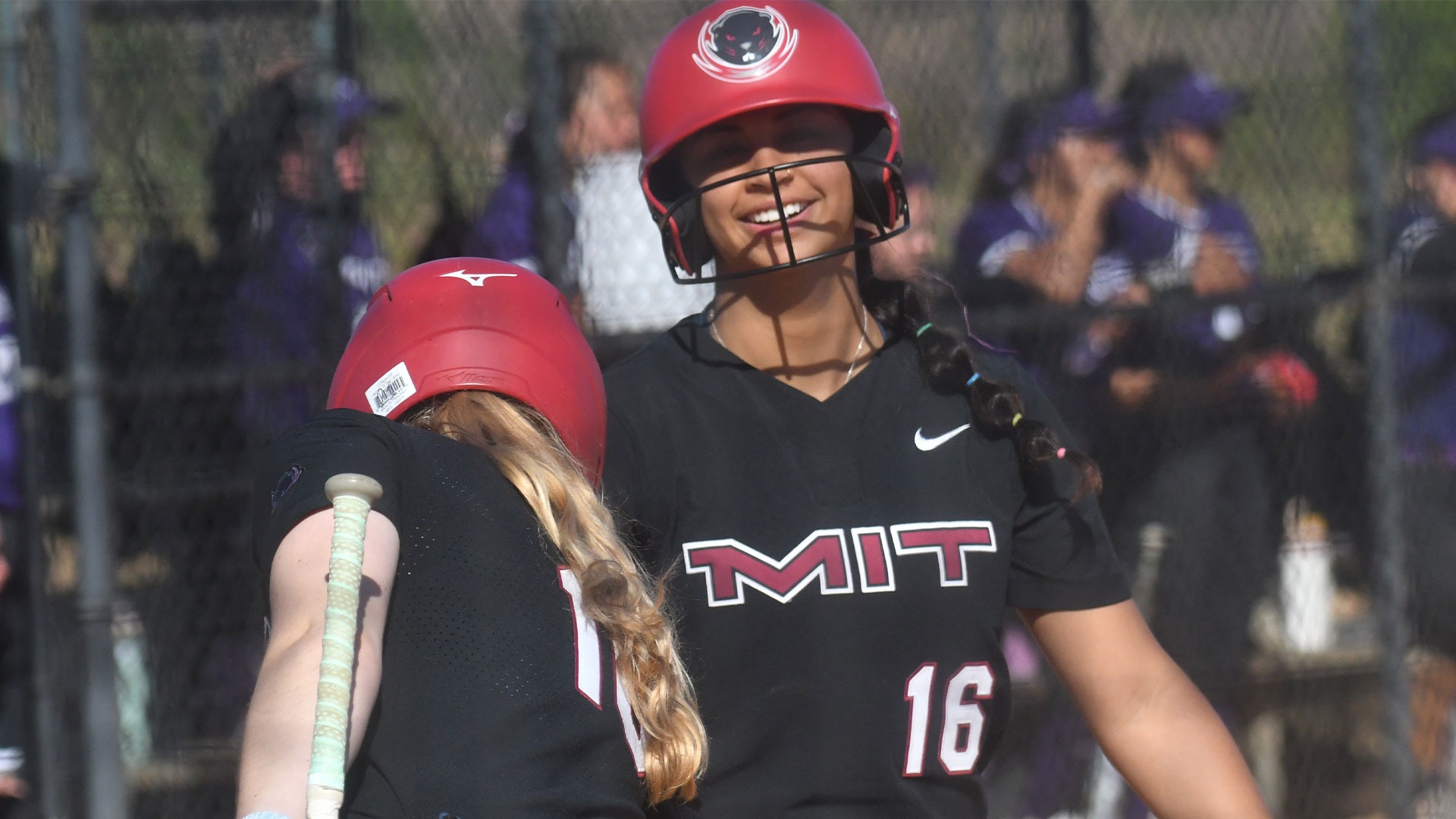 Ari Kumar and Layla Thiessen smiling at home plate