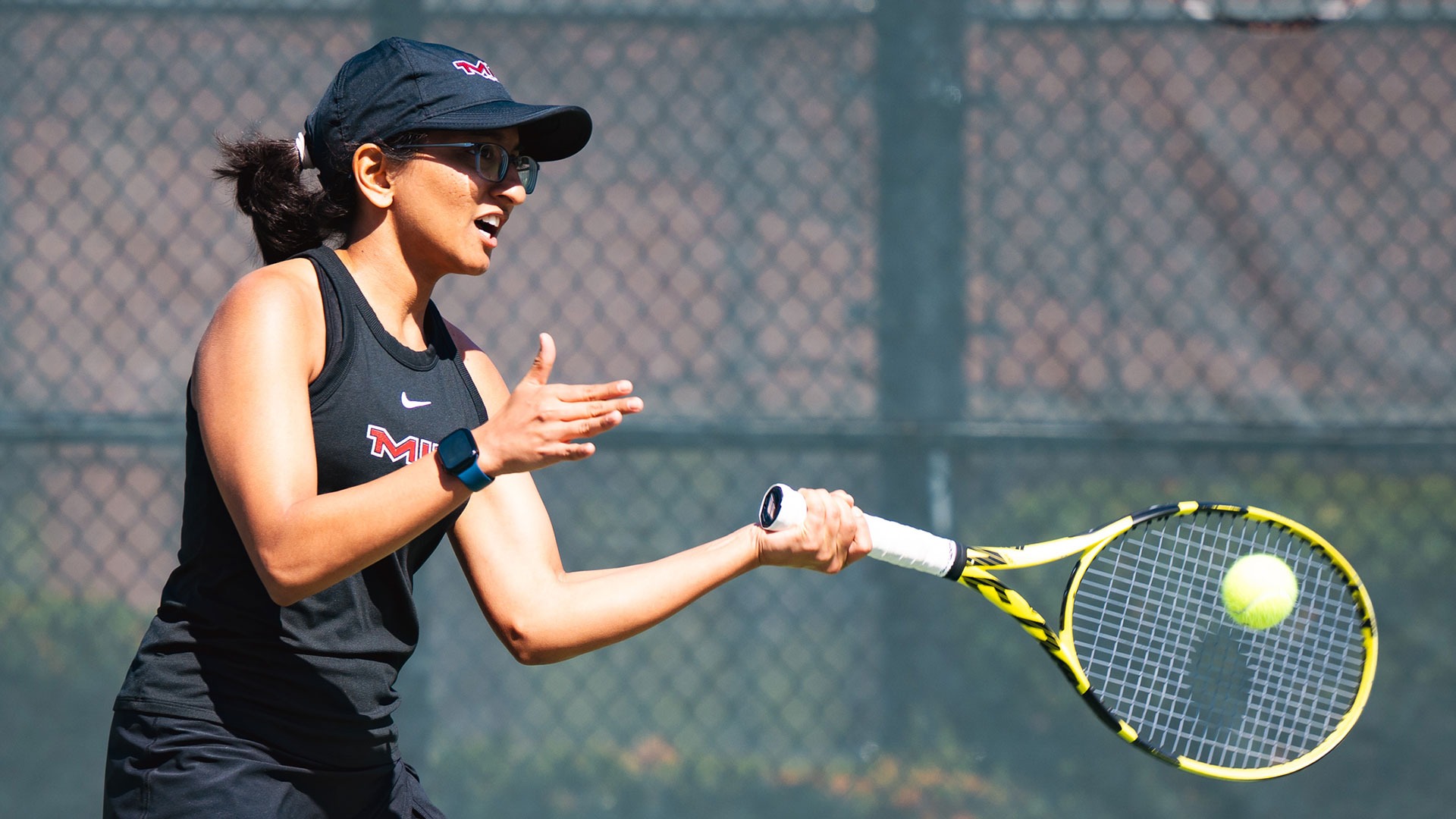 Saina Deshpande hitting the tennis ball with her racket