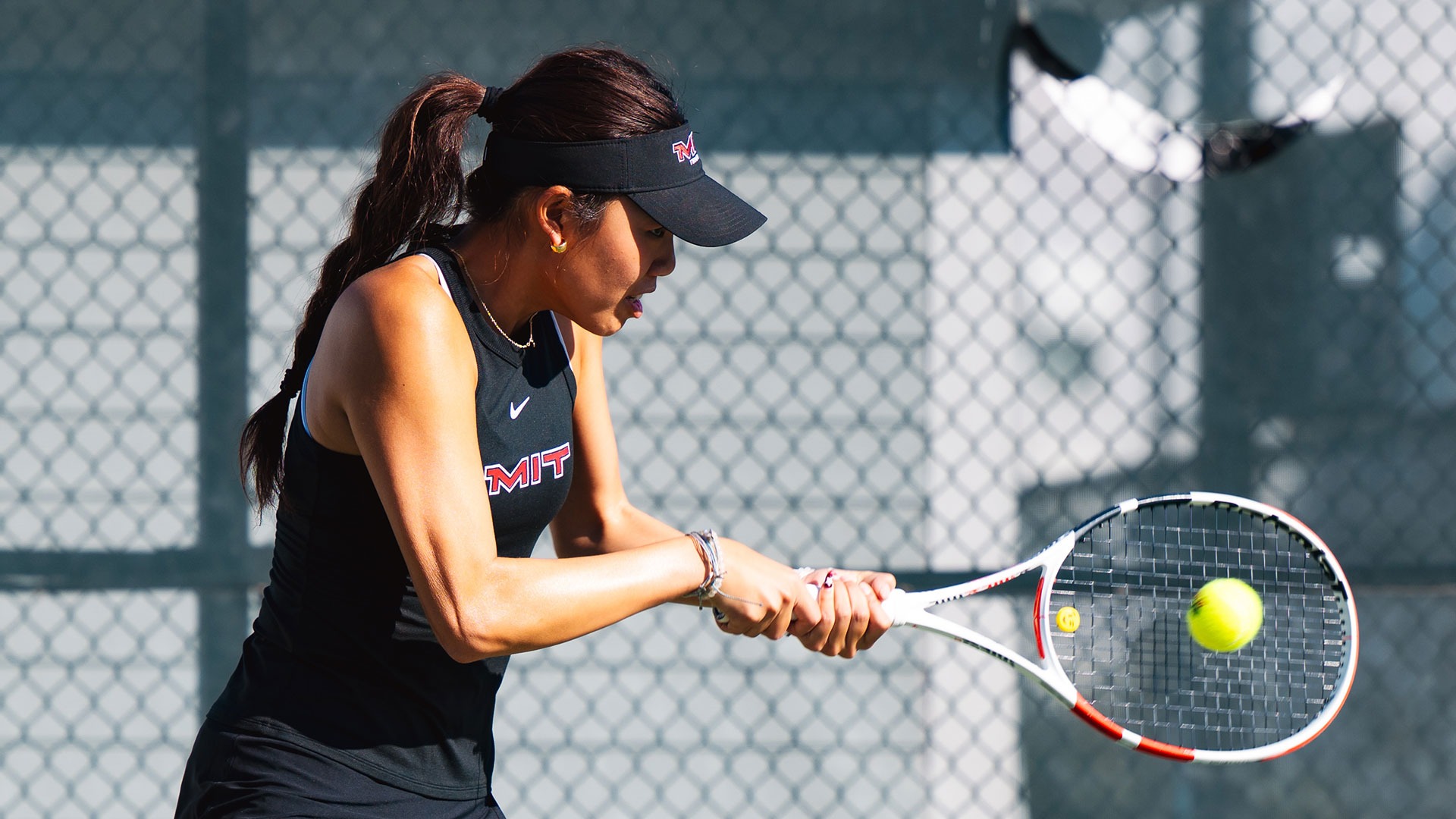 Carley Chen hitting the tennis ball with her racket