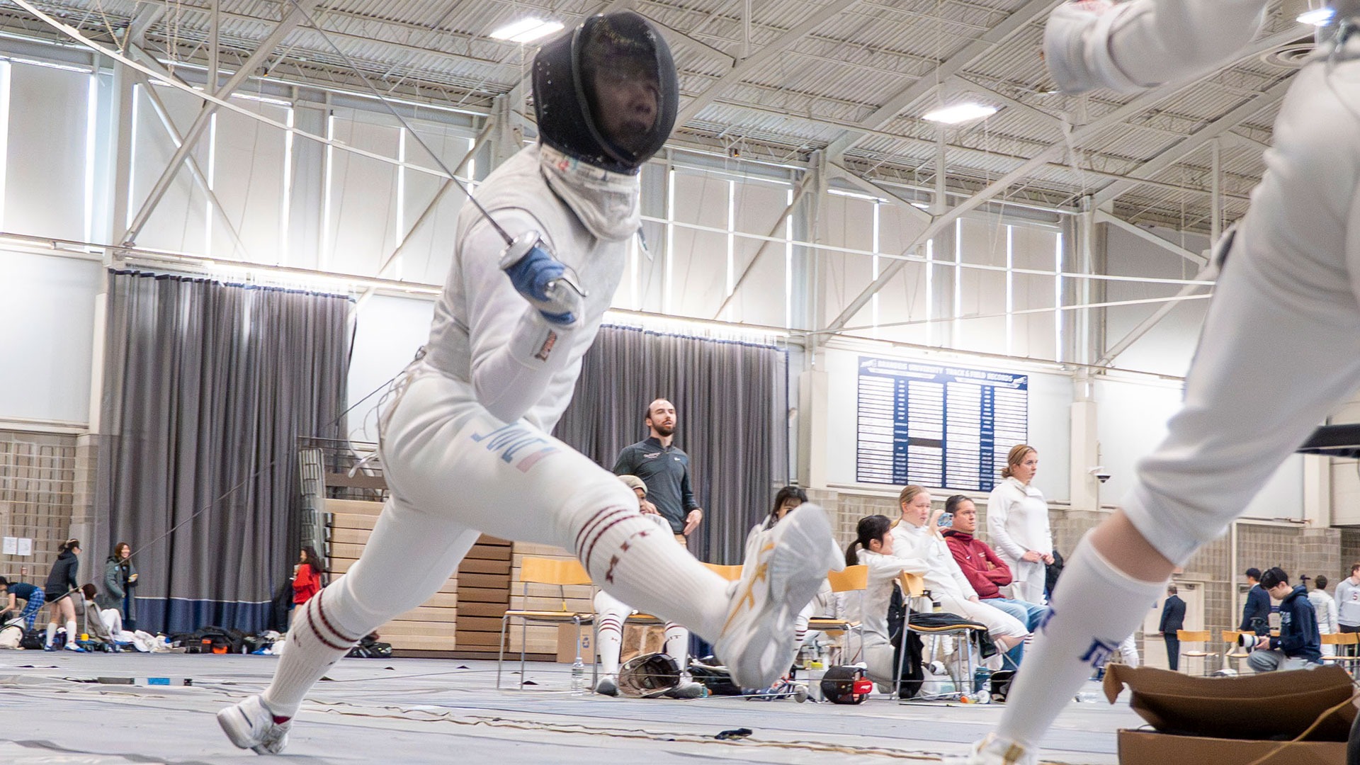 Niles Liu lunging towards his opponent