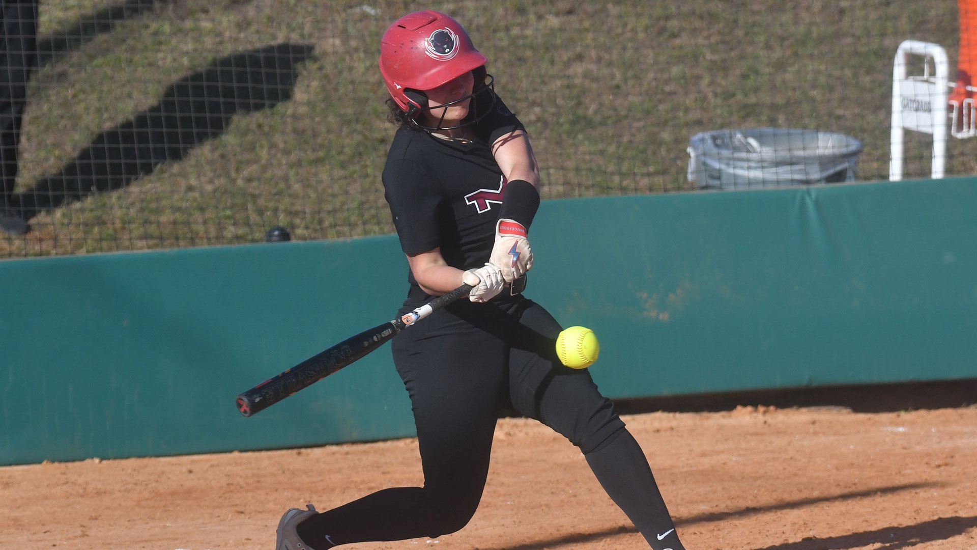 Olivia Scarpaci hitting a softball