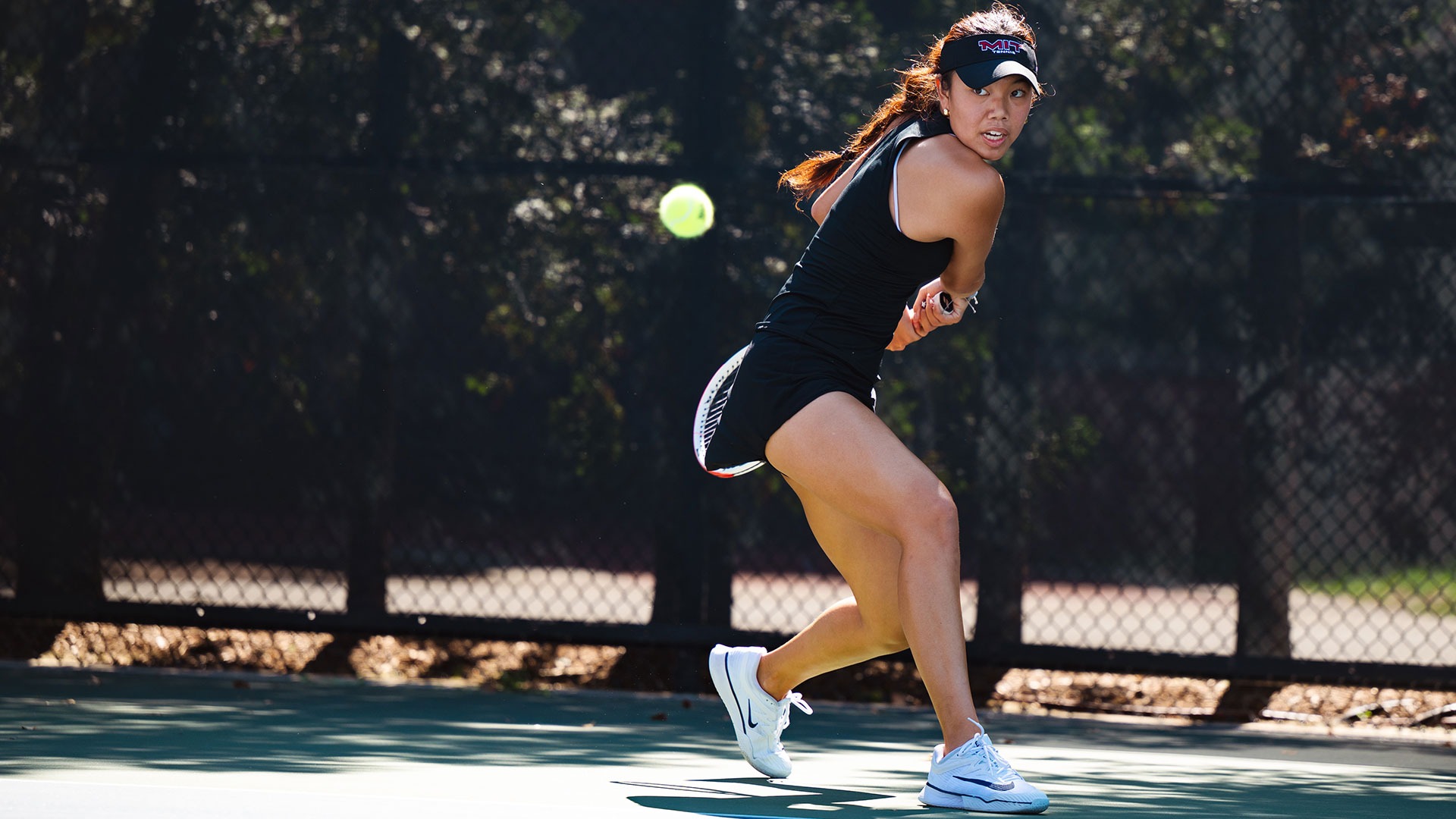Carley Chen in the process of hitting the tennis ball with her racket