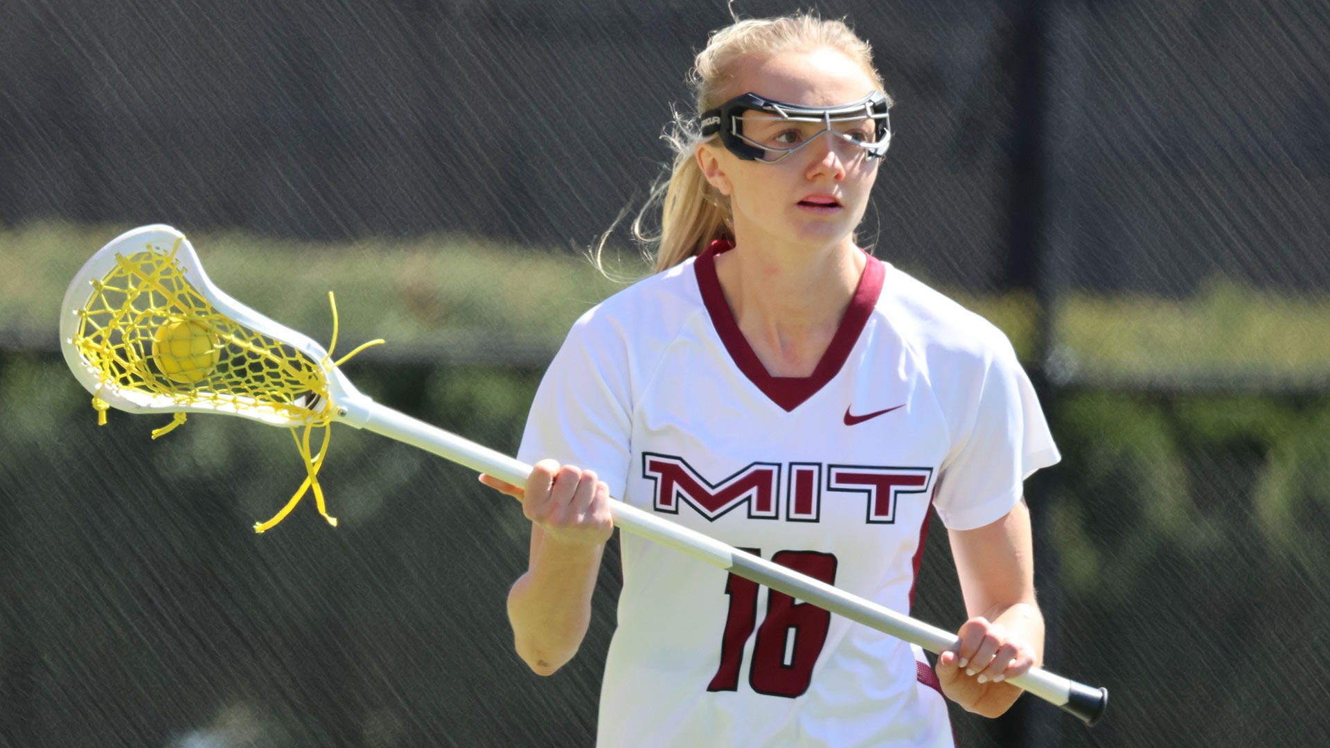 Ashley Thomas holding her lacrosse stick