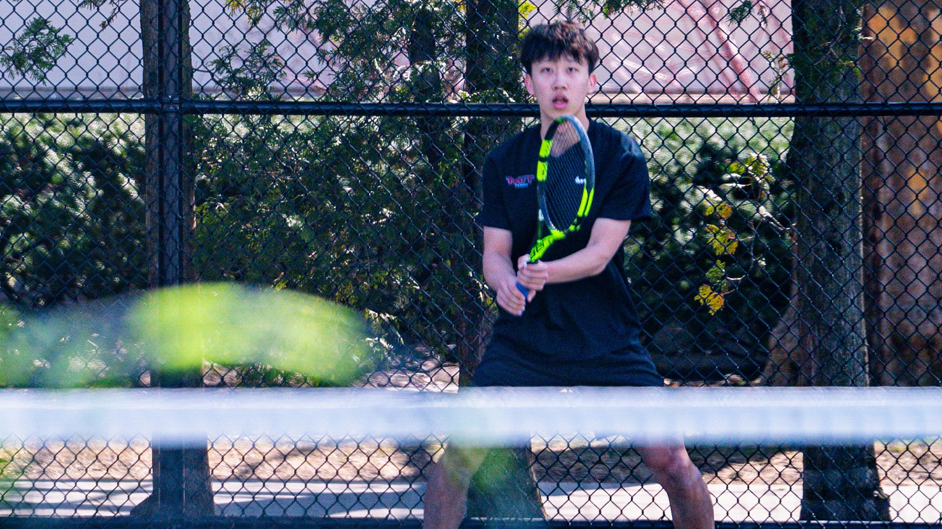 Jeremy Yu getting ready to receive a serve