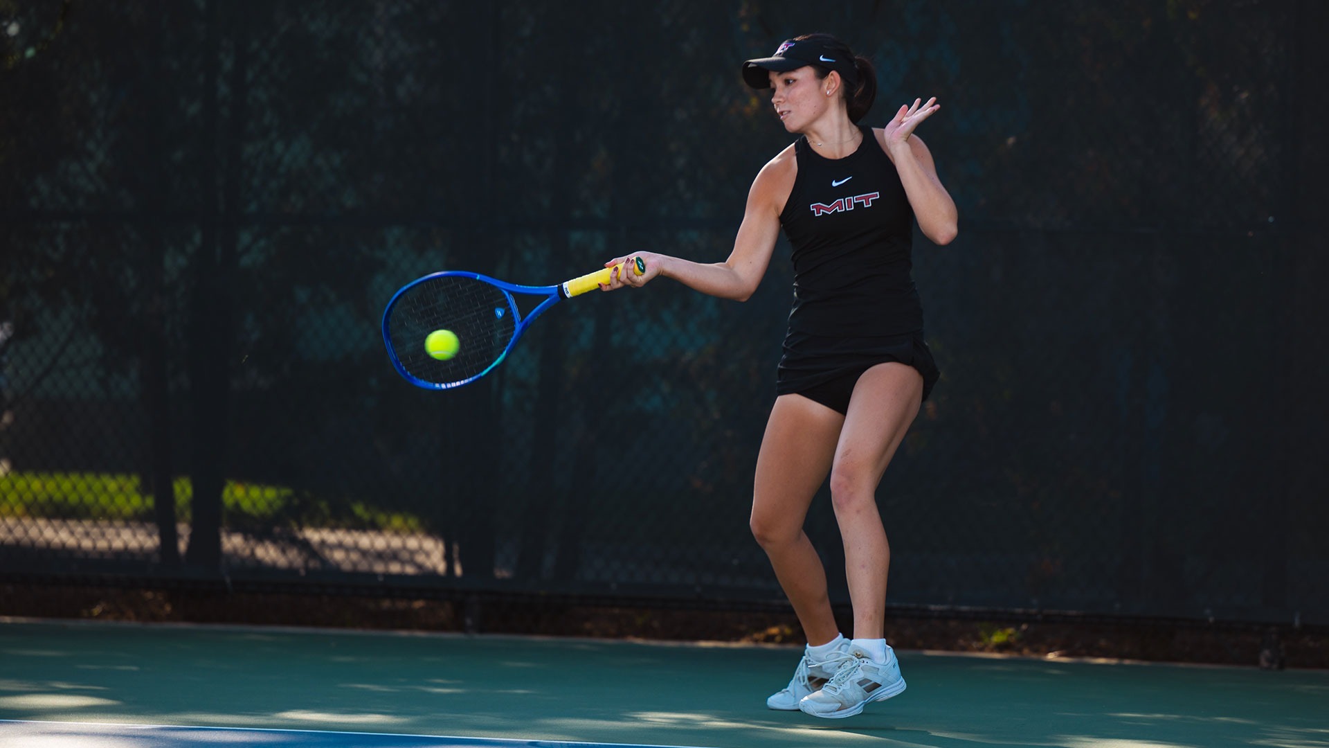 Katie Driscoll hitting a tennis ball with her racket