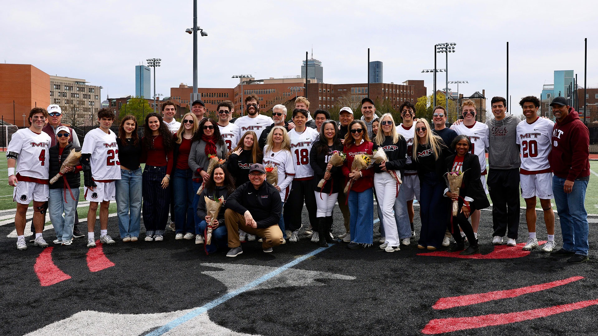 The seniors on the men's lacrosse team in a group photo with their families