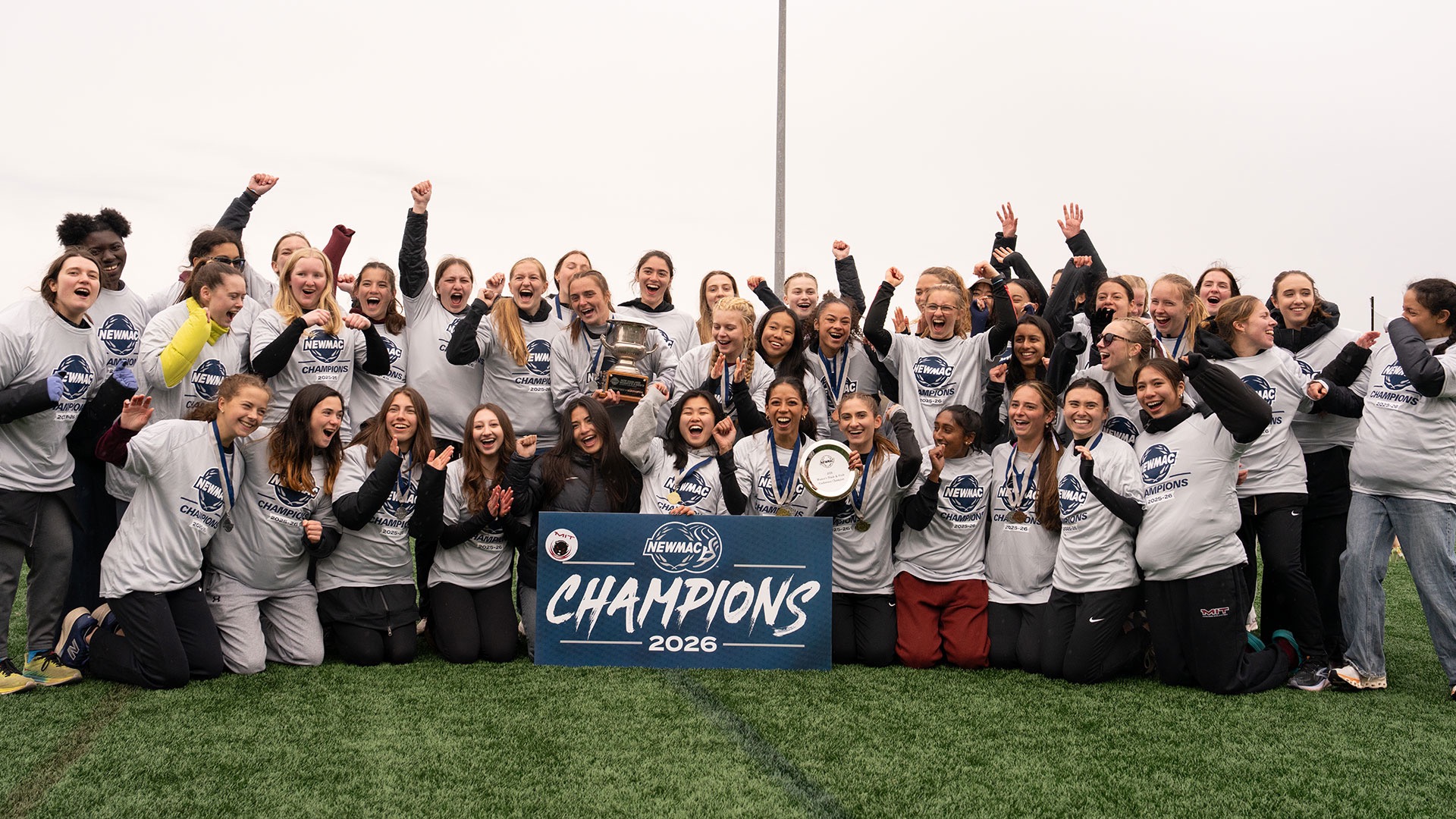 MIT women's track and field with the NEWMAC Championship trophy