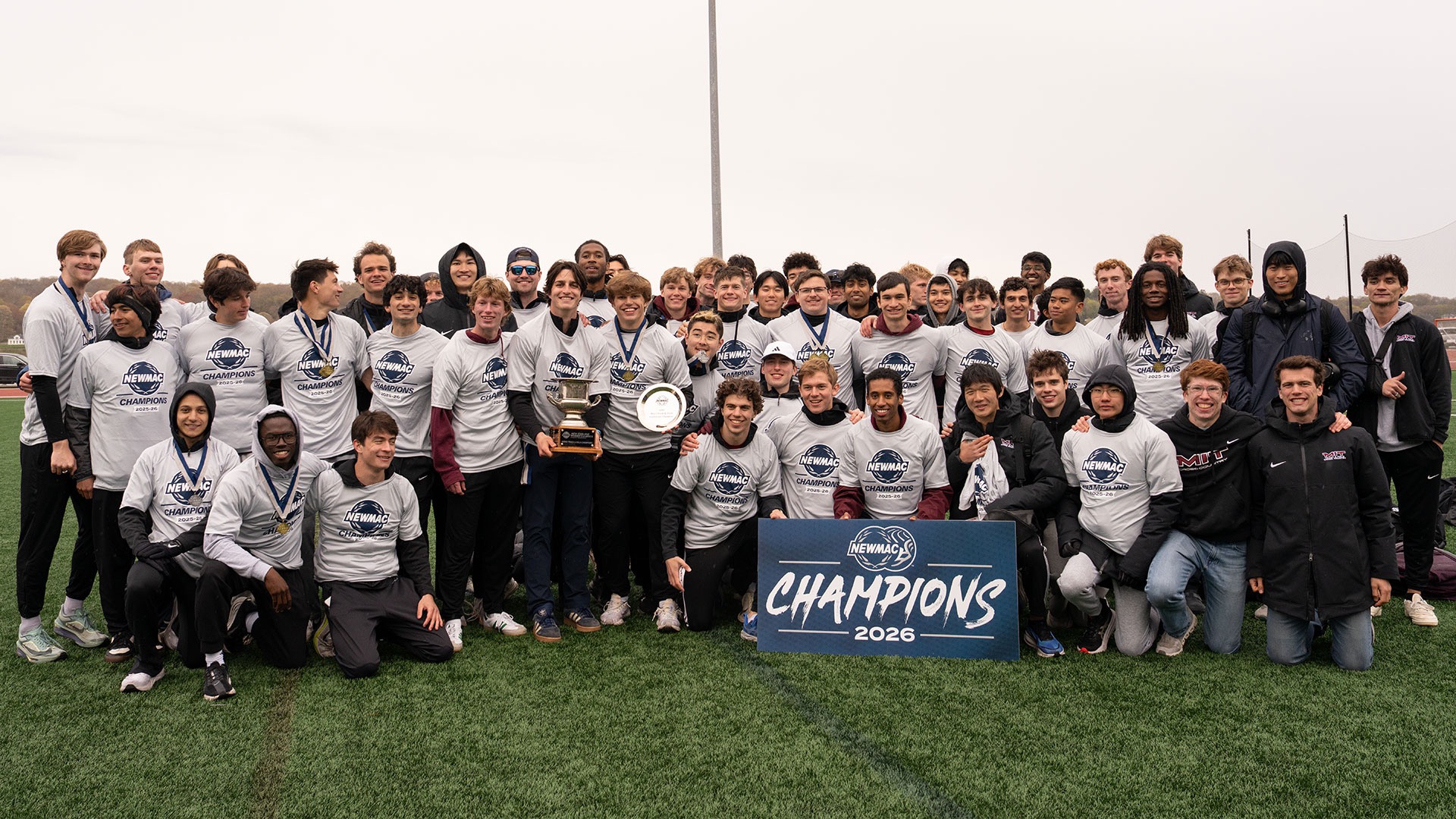 MIT men's track and field with the NEWMAC championship trophy