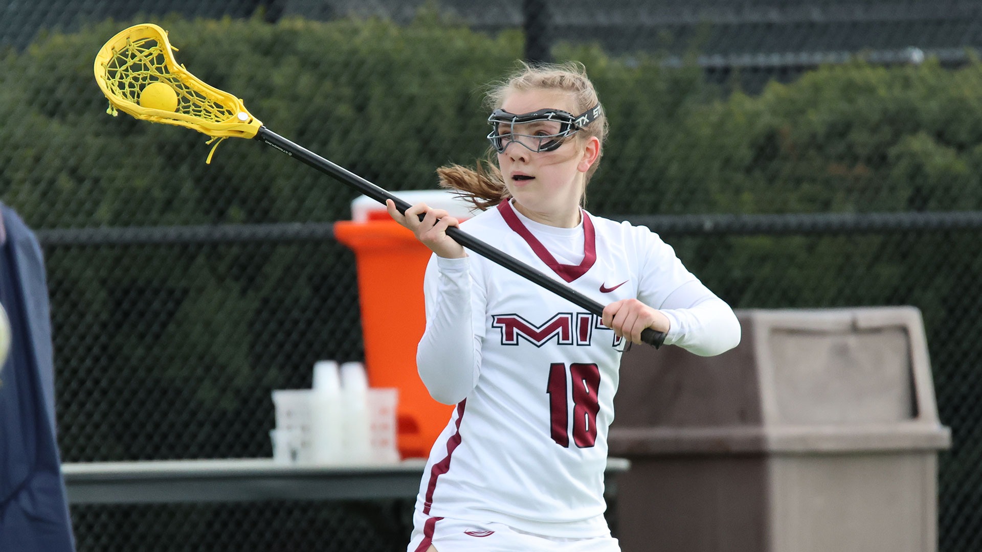 Kelsey Dwyer running down the field with a ball in her lacrosse stick