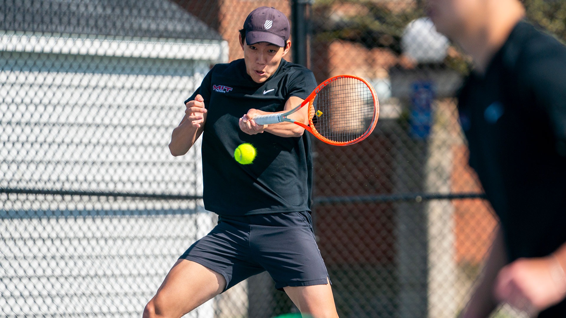 Adam Sun hitting a tennis ball