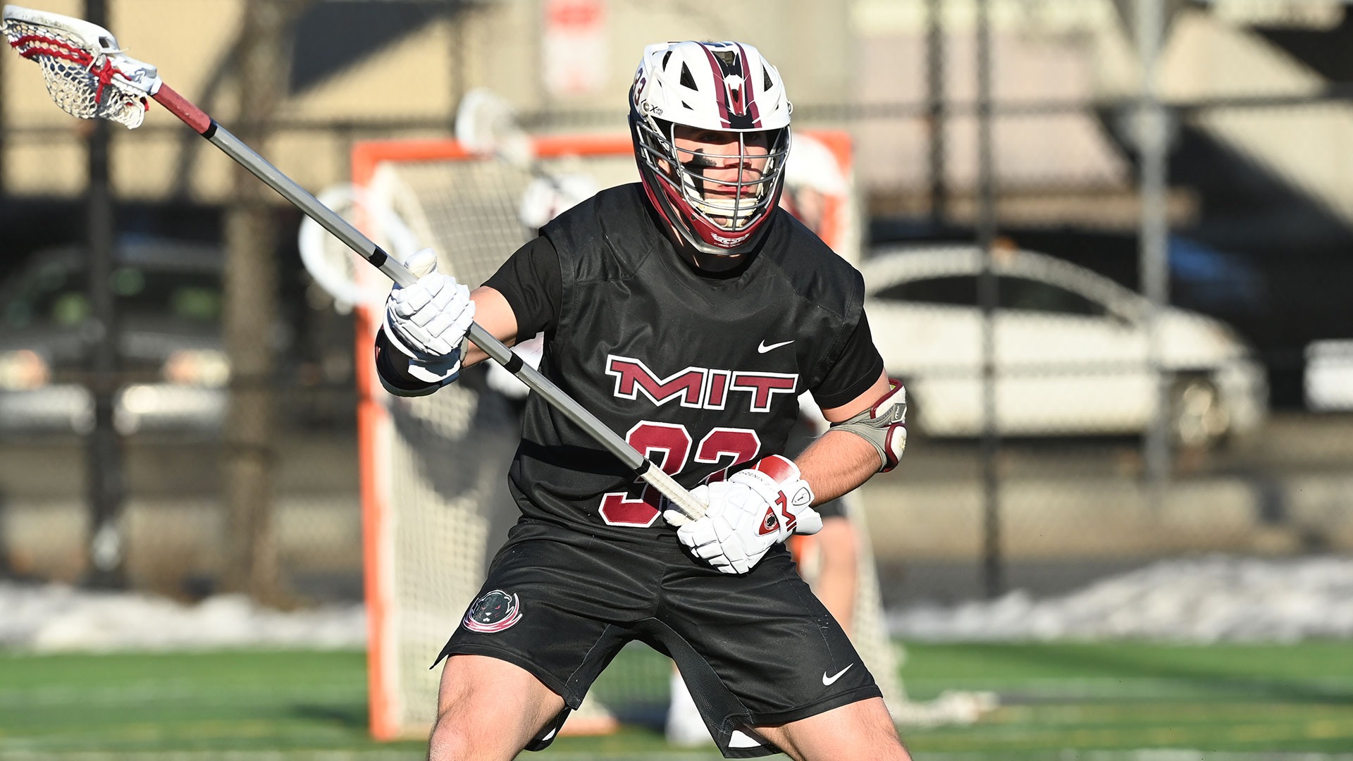 Stone Smith standing on the field holding his lacrosse stick