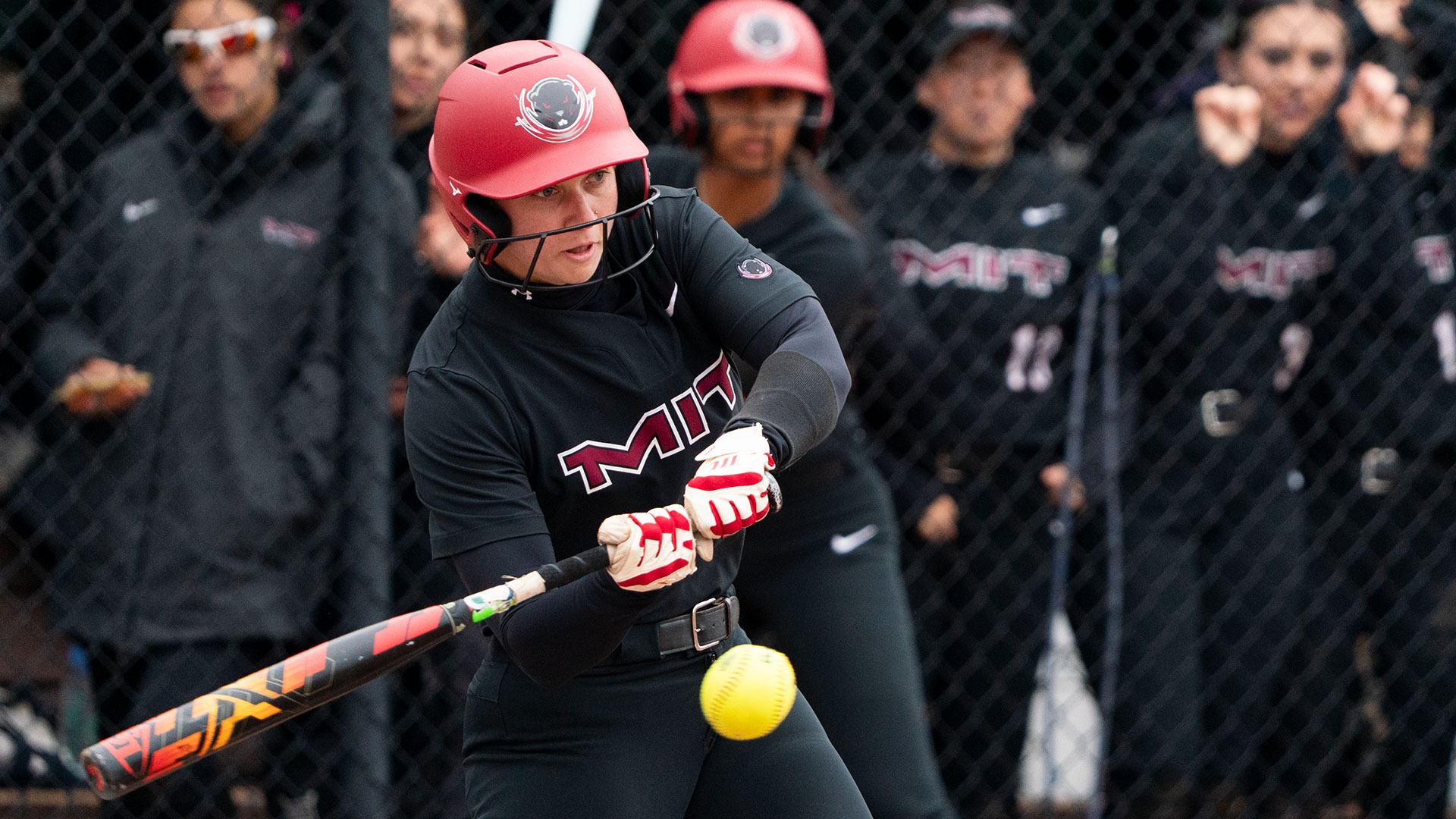 Ava Ladd hitting a softball