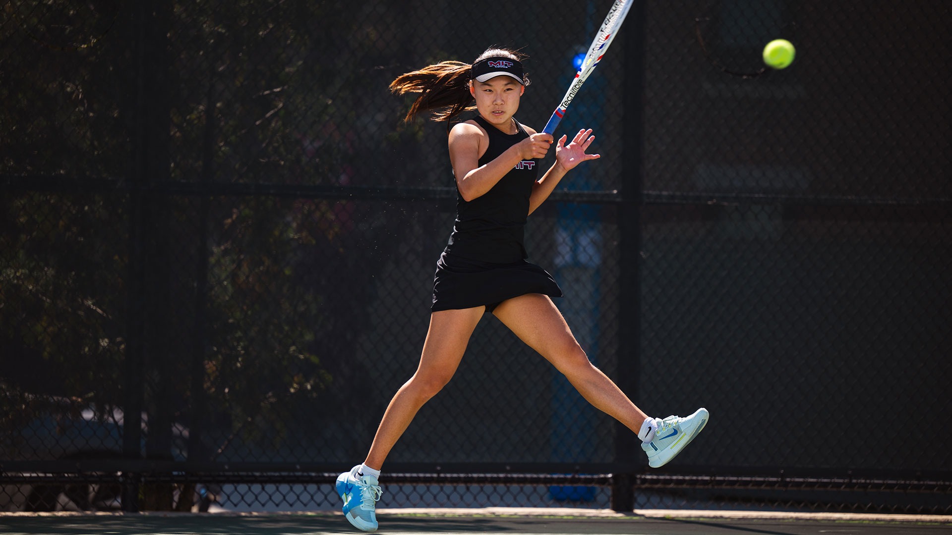 Sophia Yang hitting the tennis ball with her racket