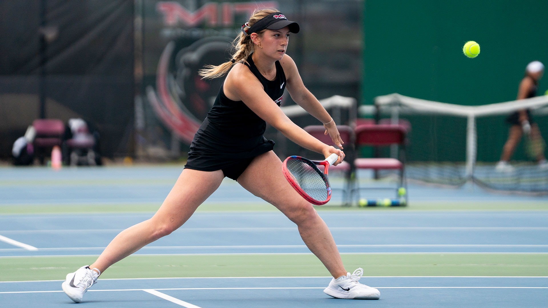 Anastasia Samets hitting the tennis ball with her racket