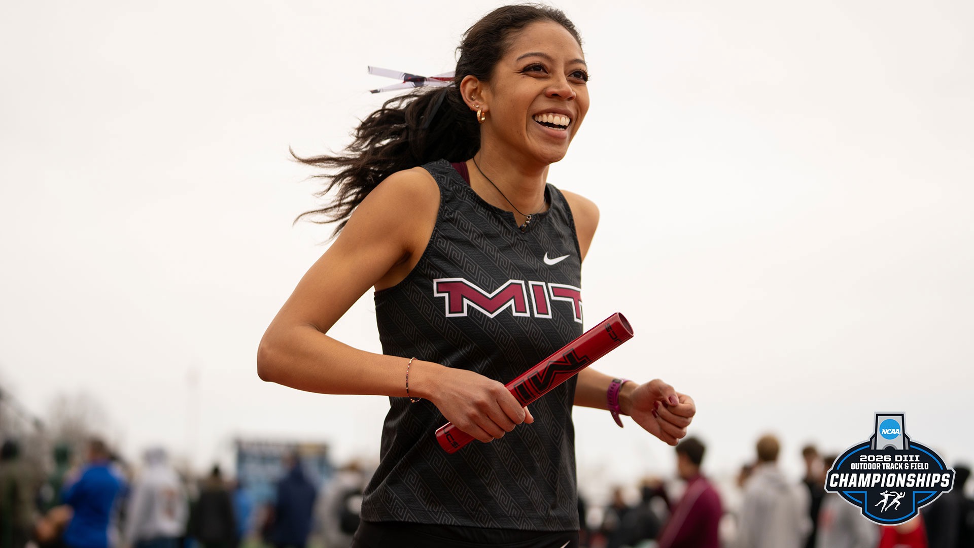 Krystal Montgomery running with a relay baton