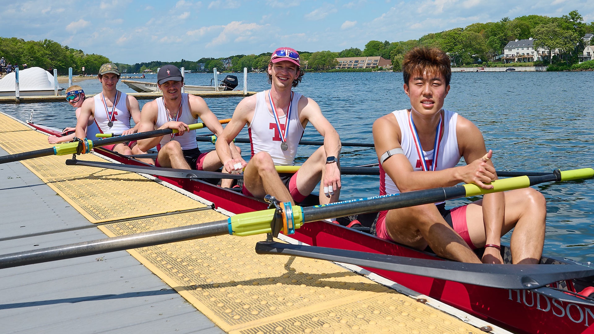men's lightweight crew varsity eight with medals in a boat