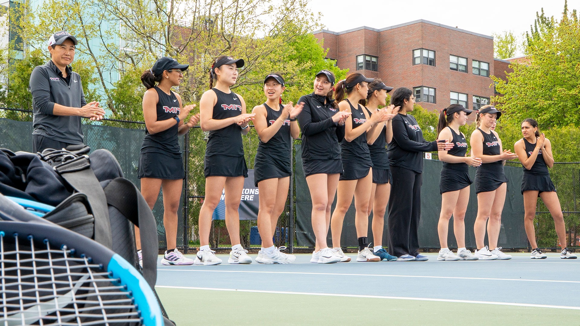 The women's tennis team clapping
