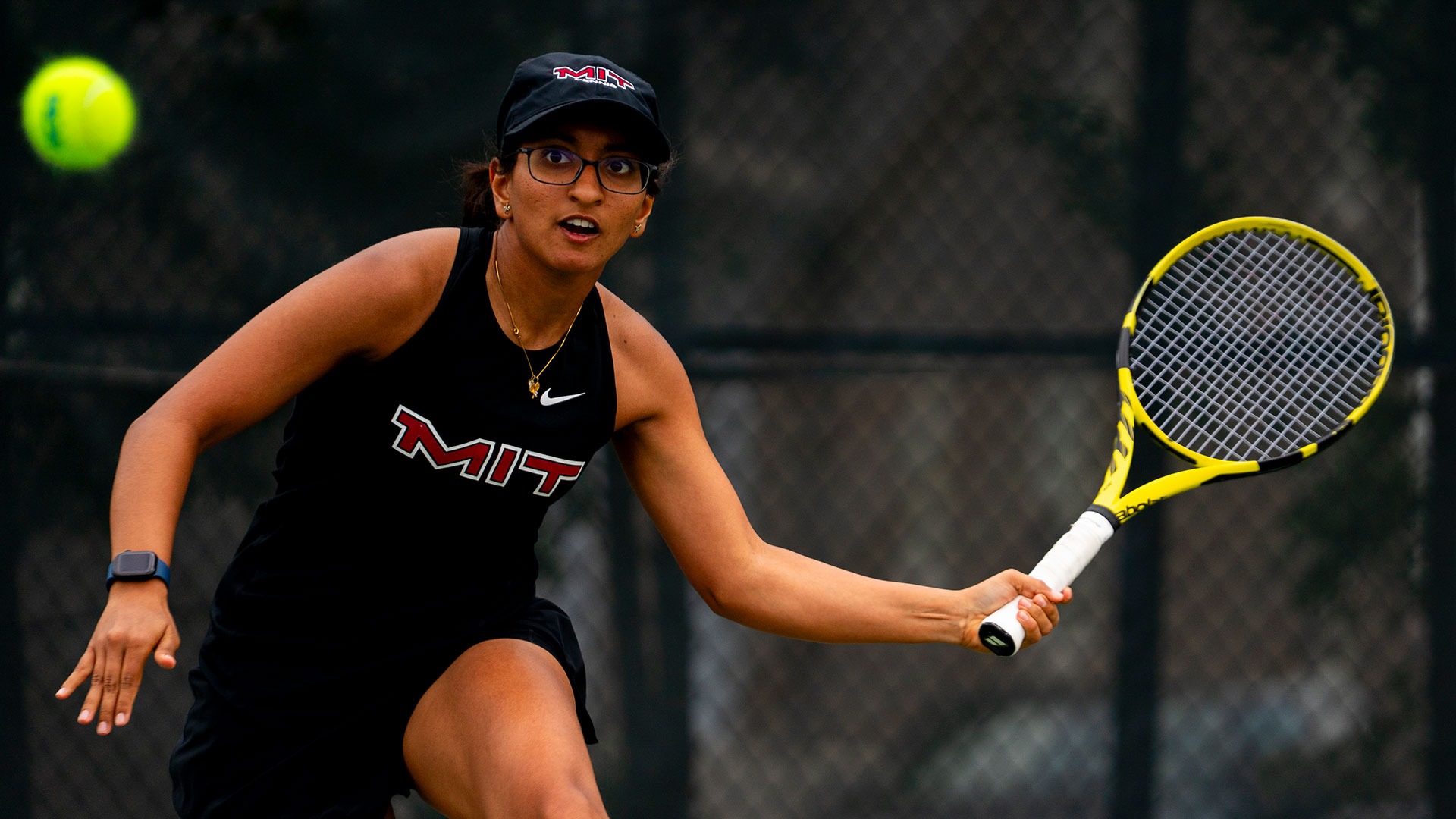 Saina Deshpande in the process of hitting a tennis ball with her racket