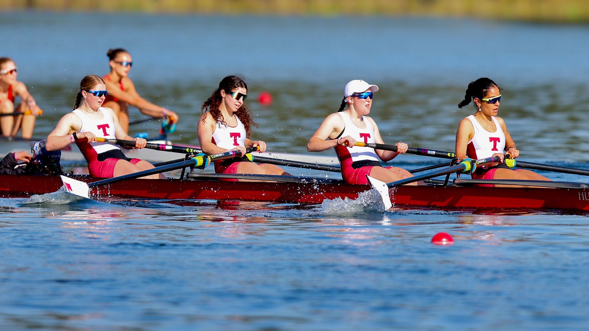 Women's Lightweight varsity four rowing in a race
