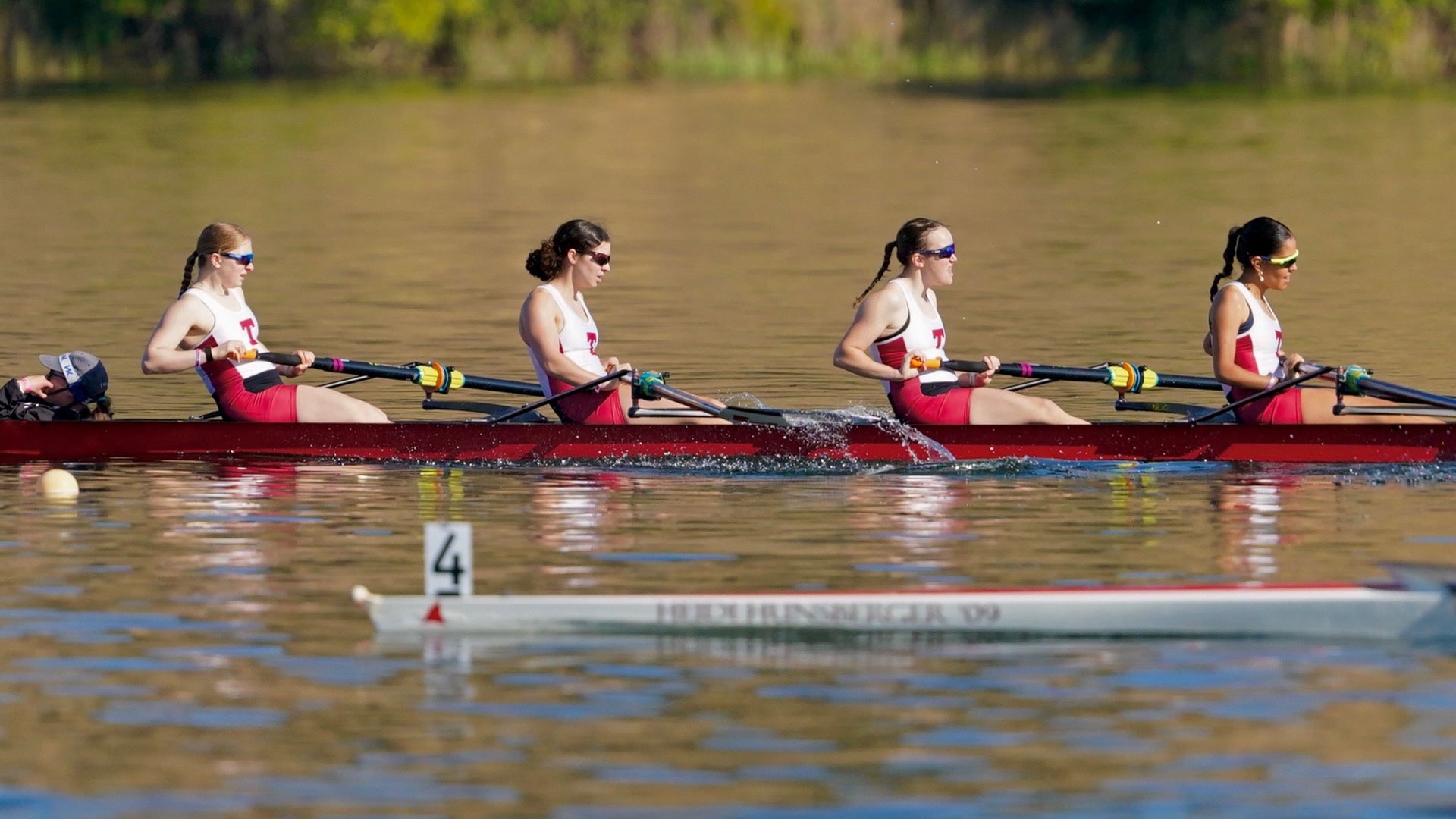 MIT women's lightweight varsity four rowing on the water