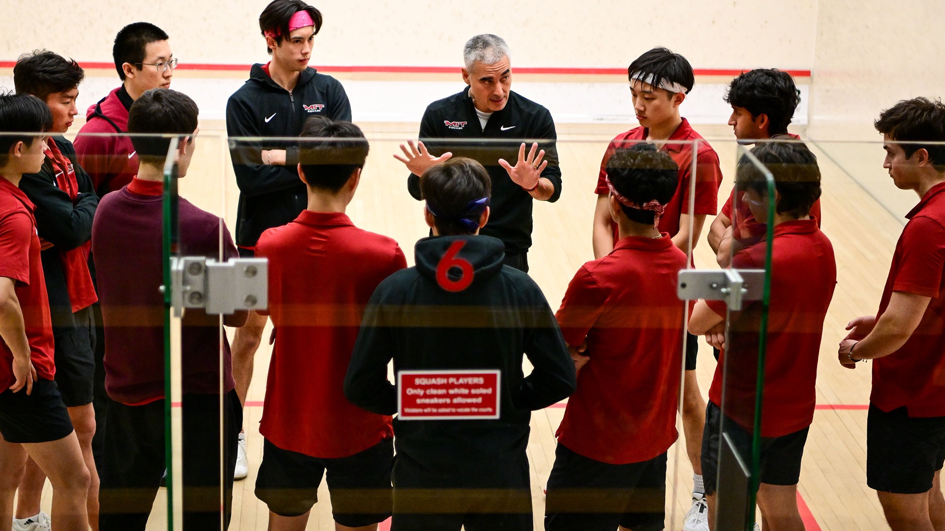 The MIT squash team in a huddle