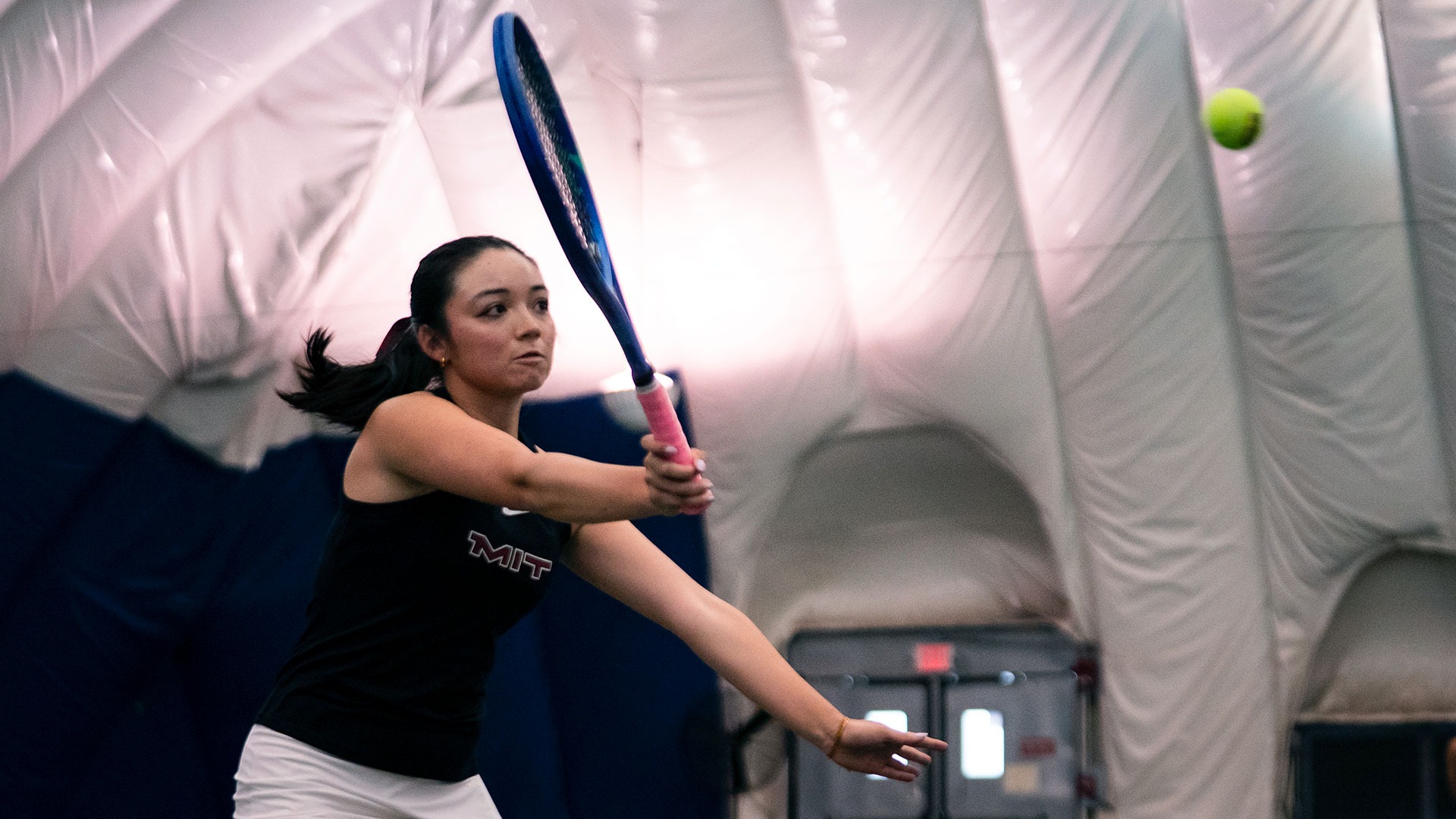 Katie Driscoll hitting the tennis ball with her racket