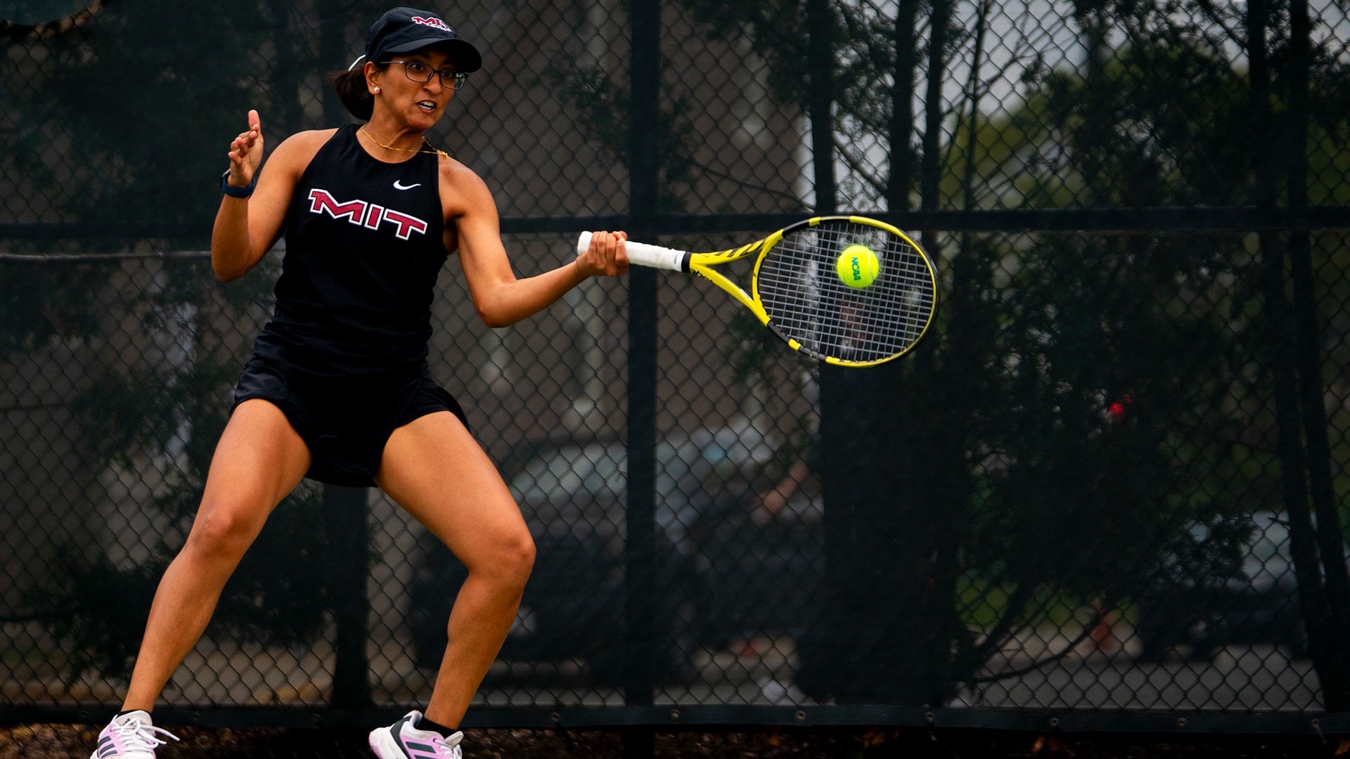 Saina Deshpande hitting a tennis ball with her racket