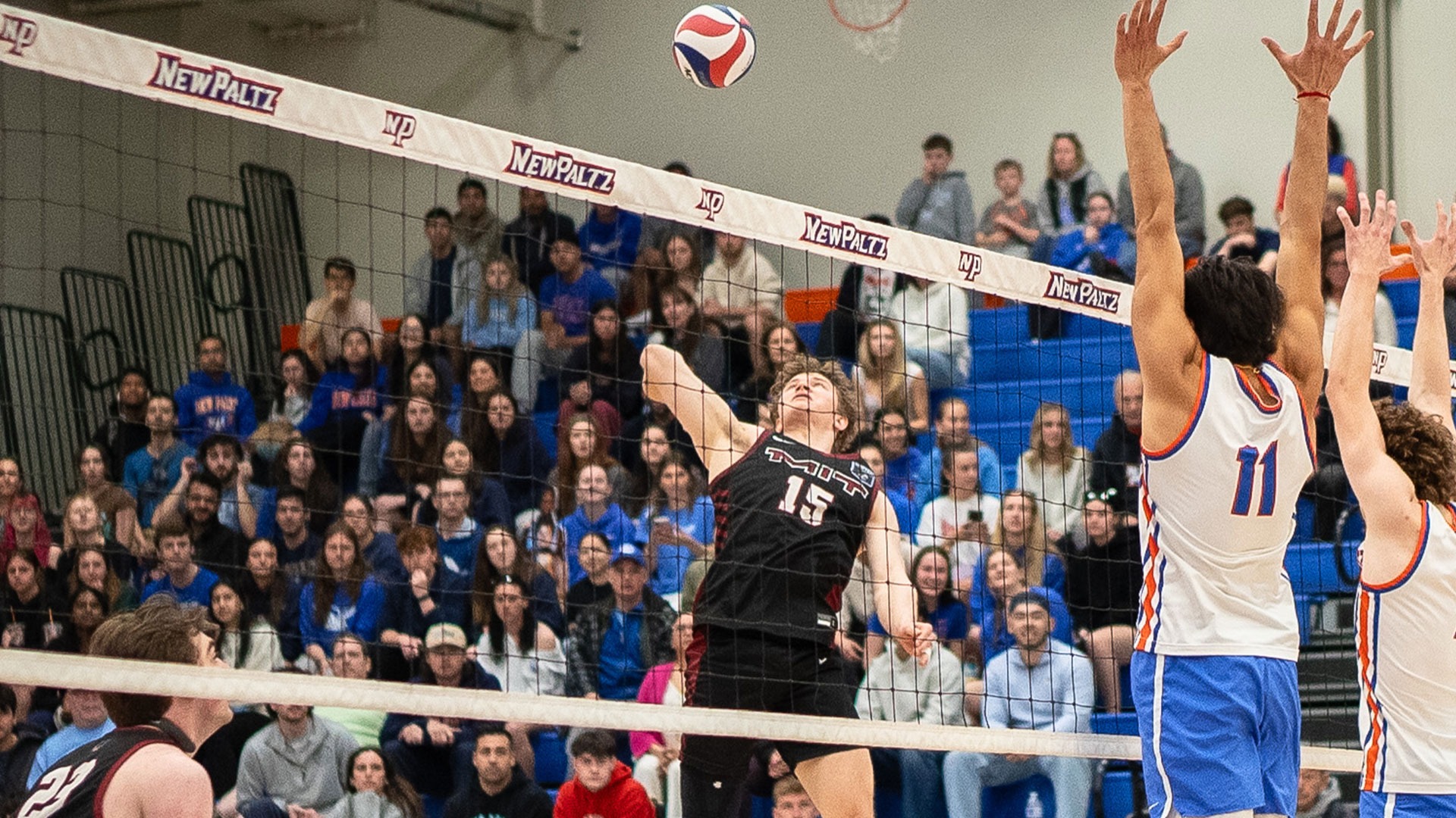 Braeden Baker going up to hit a volleyball