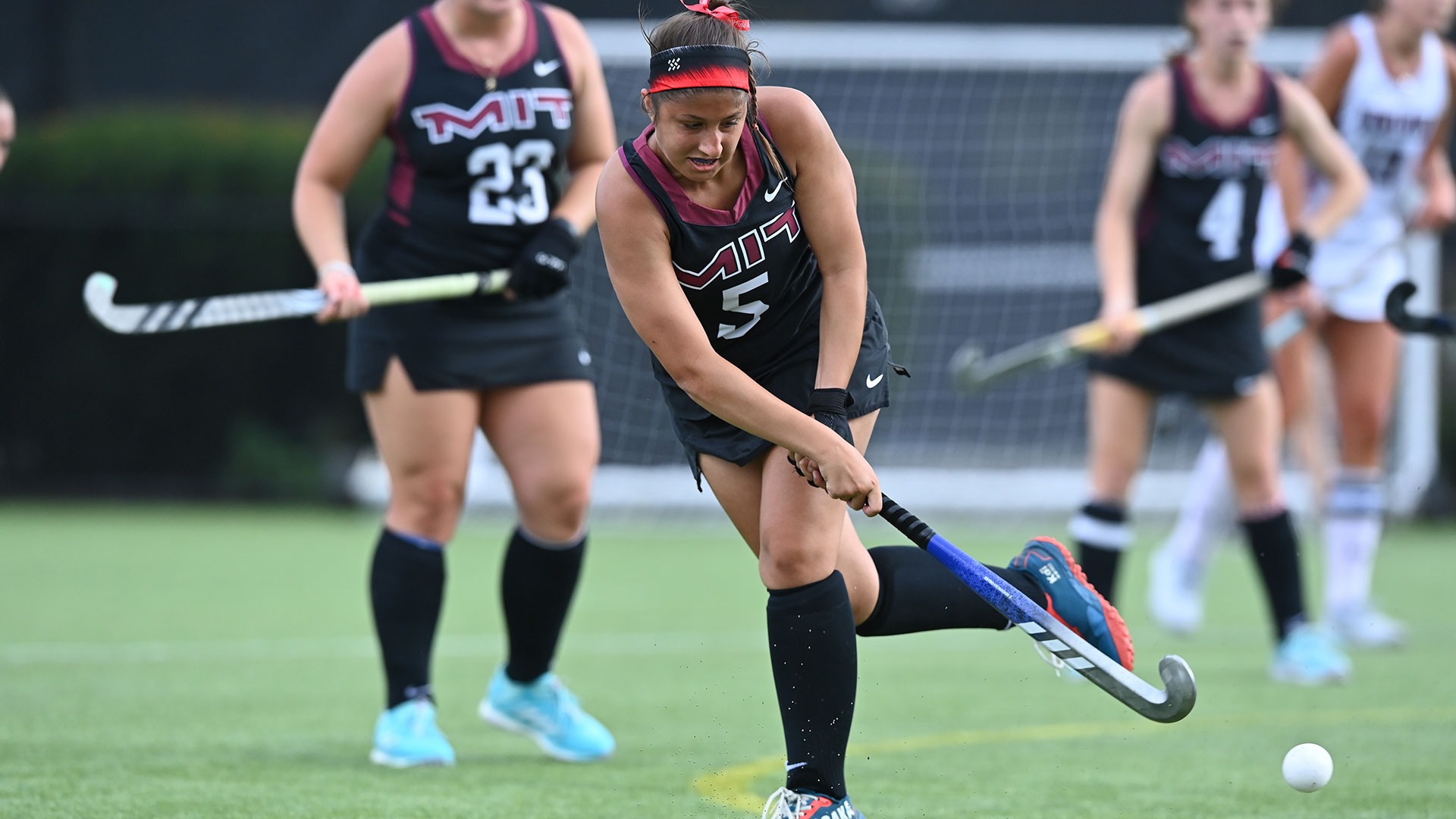 Sammi Blocher hitting the ball with her field hockey stick