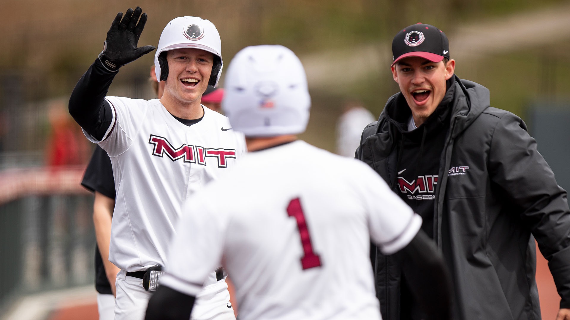 Owen Malone celebrating with teammates at the dugout