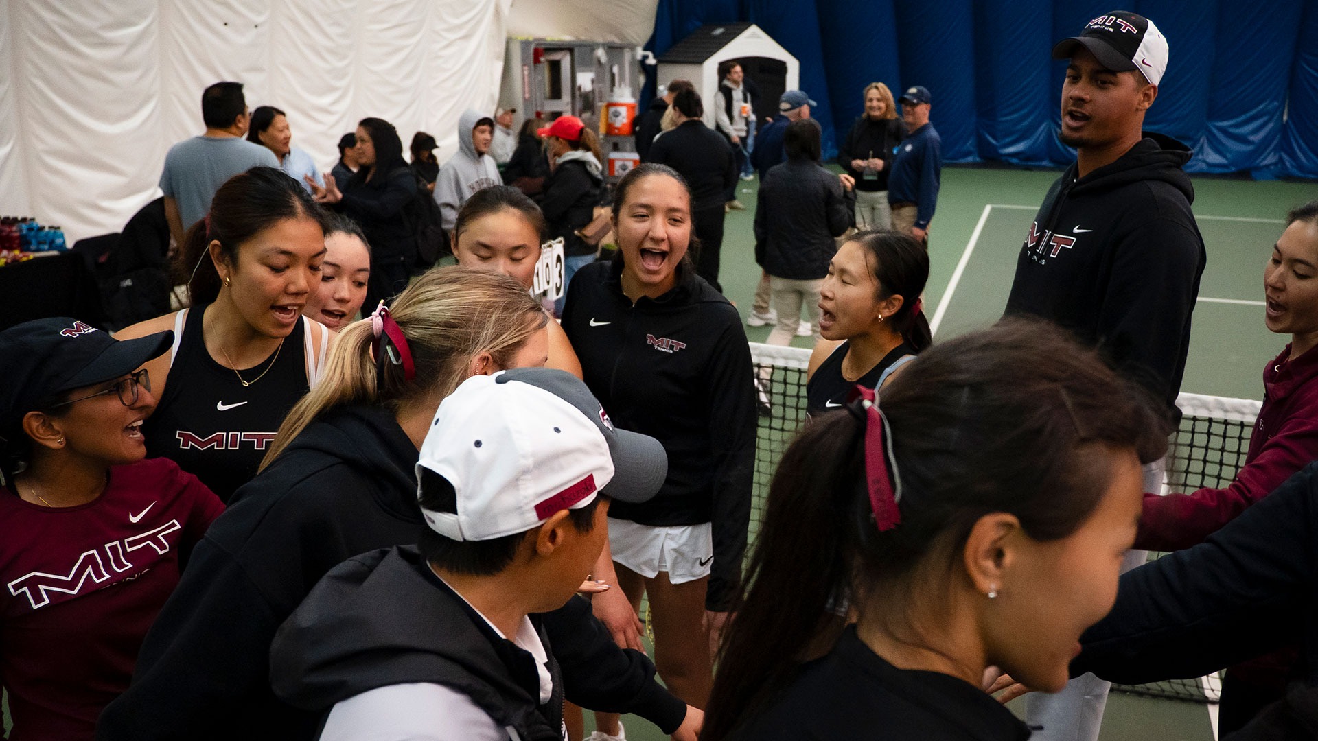 The women's tennis team in a huddle