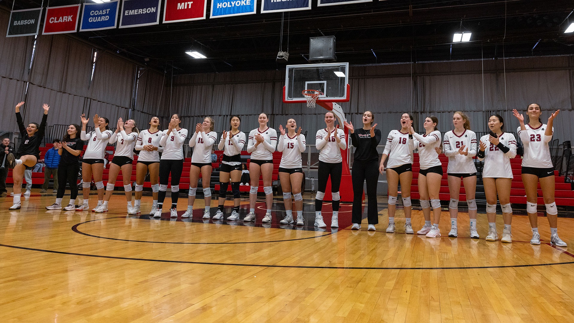 The women's volleyball team standing in a line