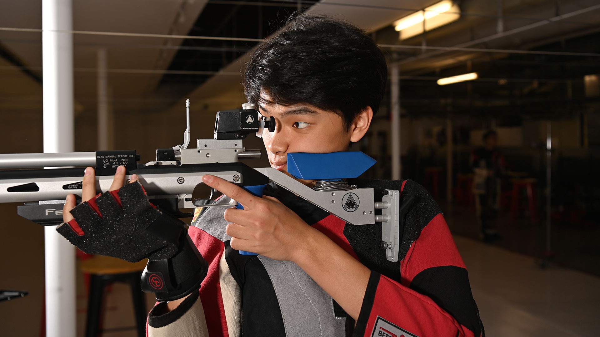 Jayden Lin aiming his rifle down range