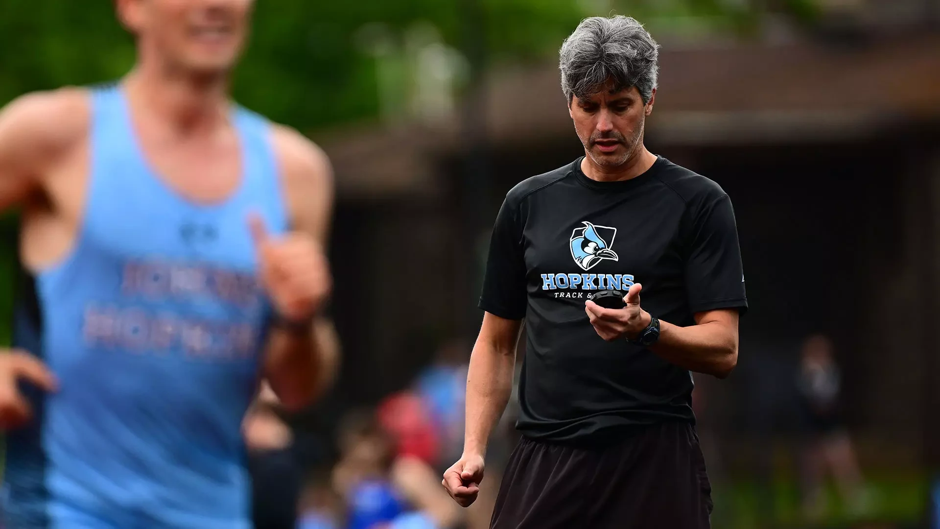 Dan Schuman coaching with a stopwatch