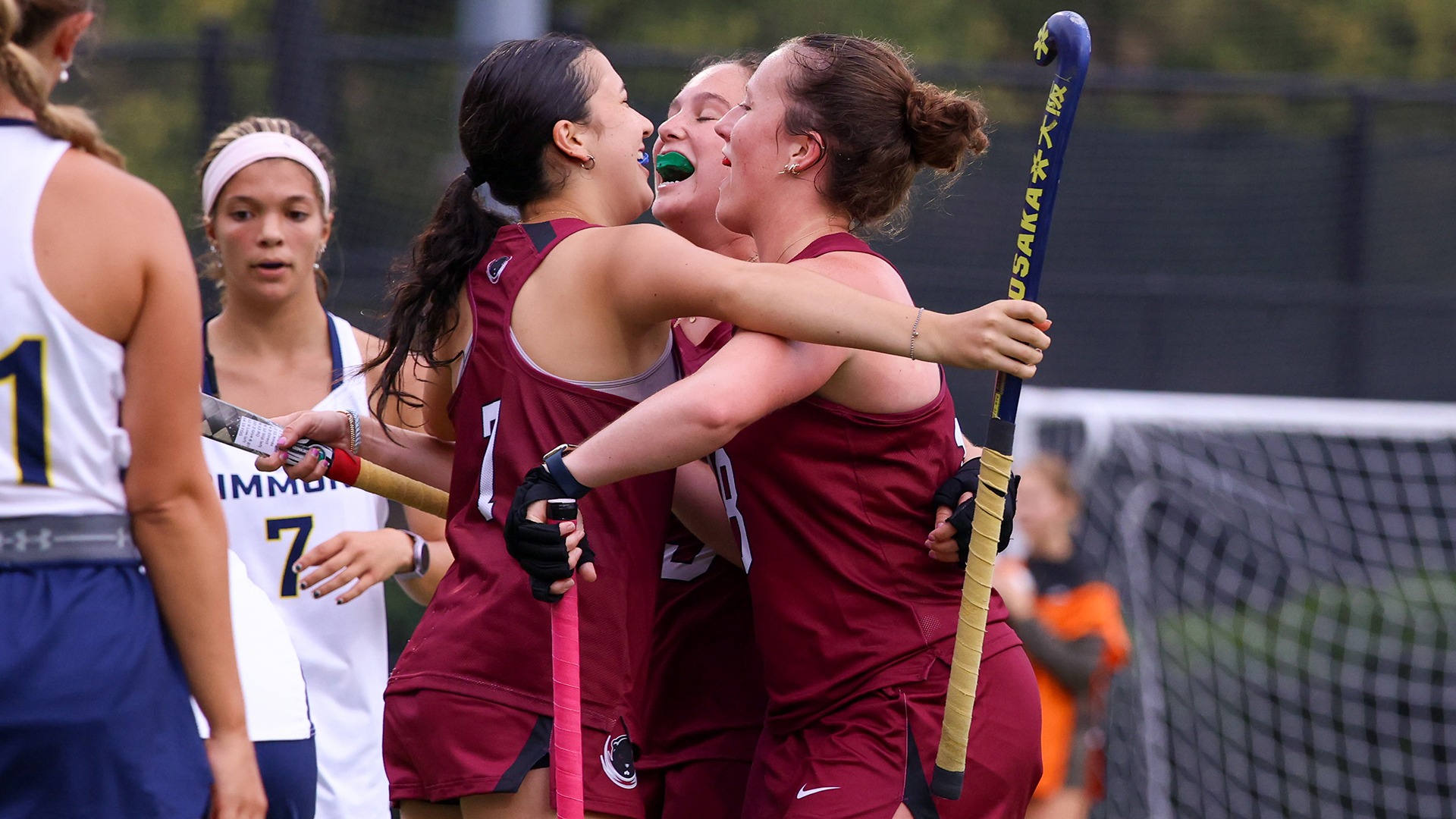 Members of the field hockey team celebrating after a goal