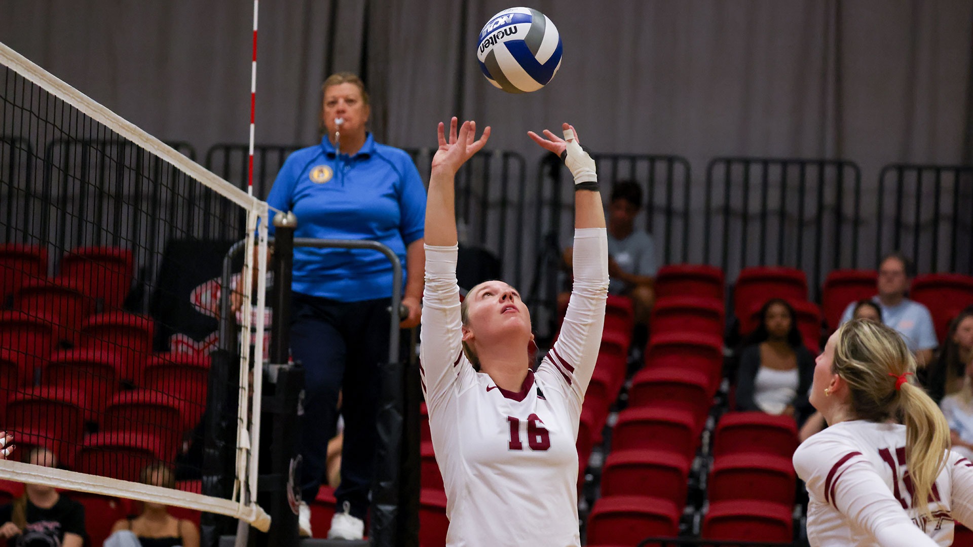 Kayleigh May setting a volleyball