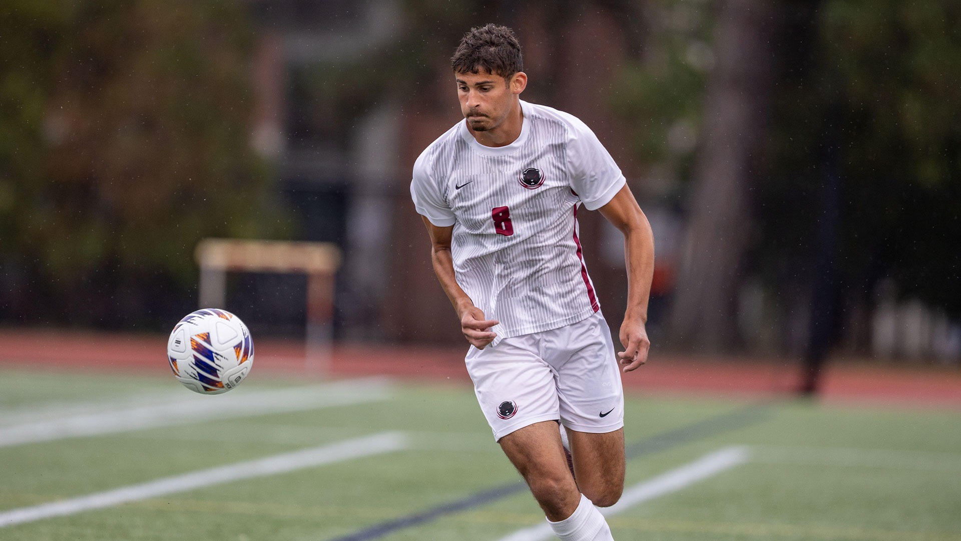 Jonah Gurion running the field with the soccer ball