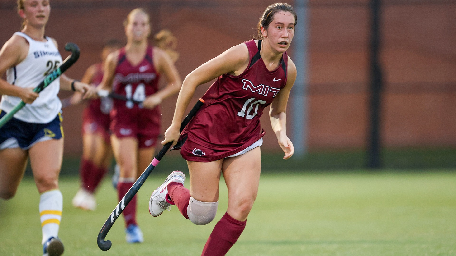 Ingrid Tomovski running down the field while holding her stick