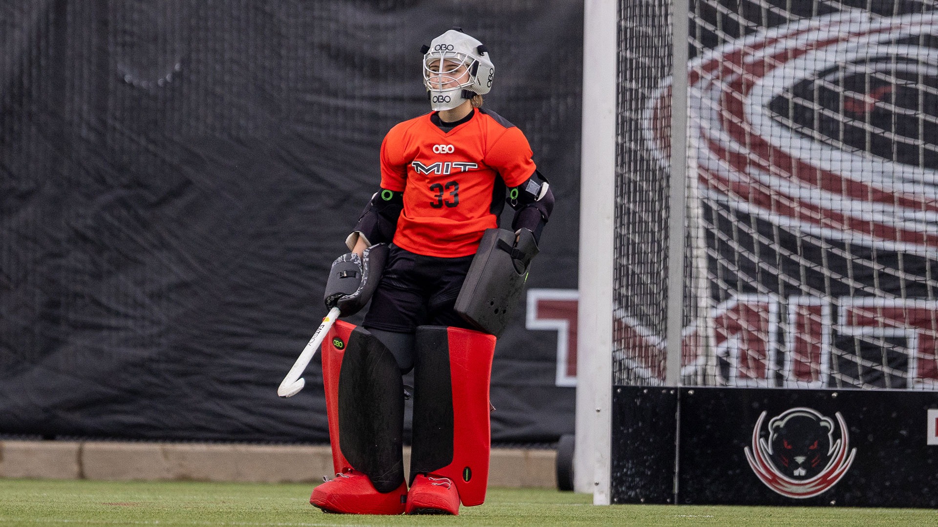 Alexia Ninios standing in front of a field hockey goal