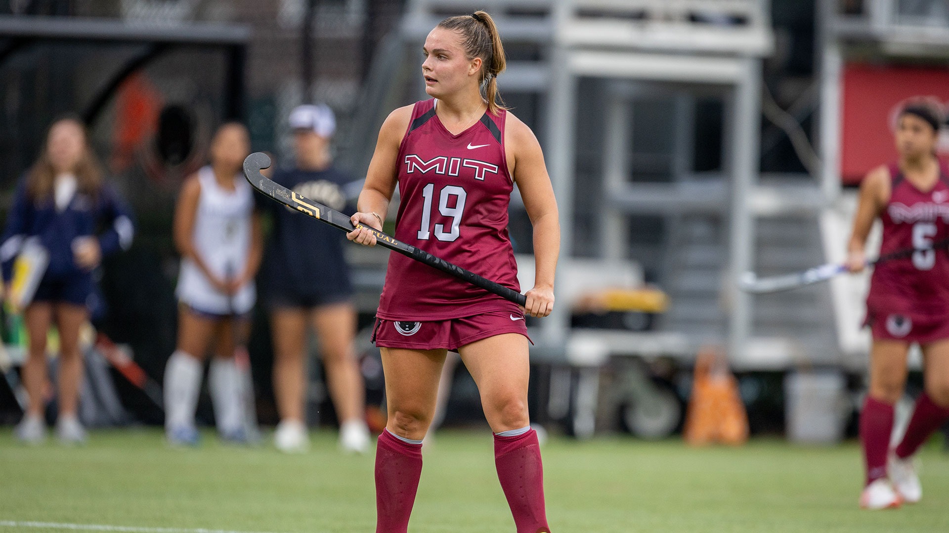 Grace Johnson standing on the field while holding a field hockey stick