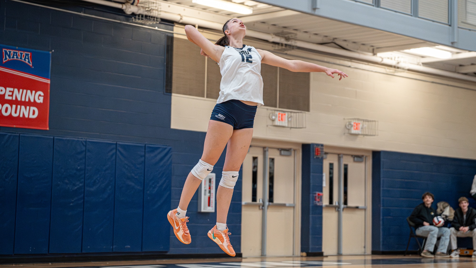 Gabi Jakubowska serves in the NAIA Opening Round vs Dillard