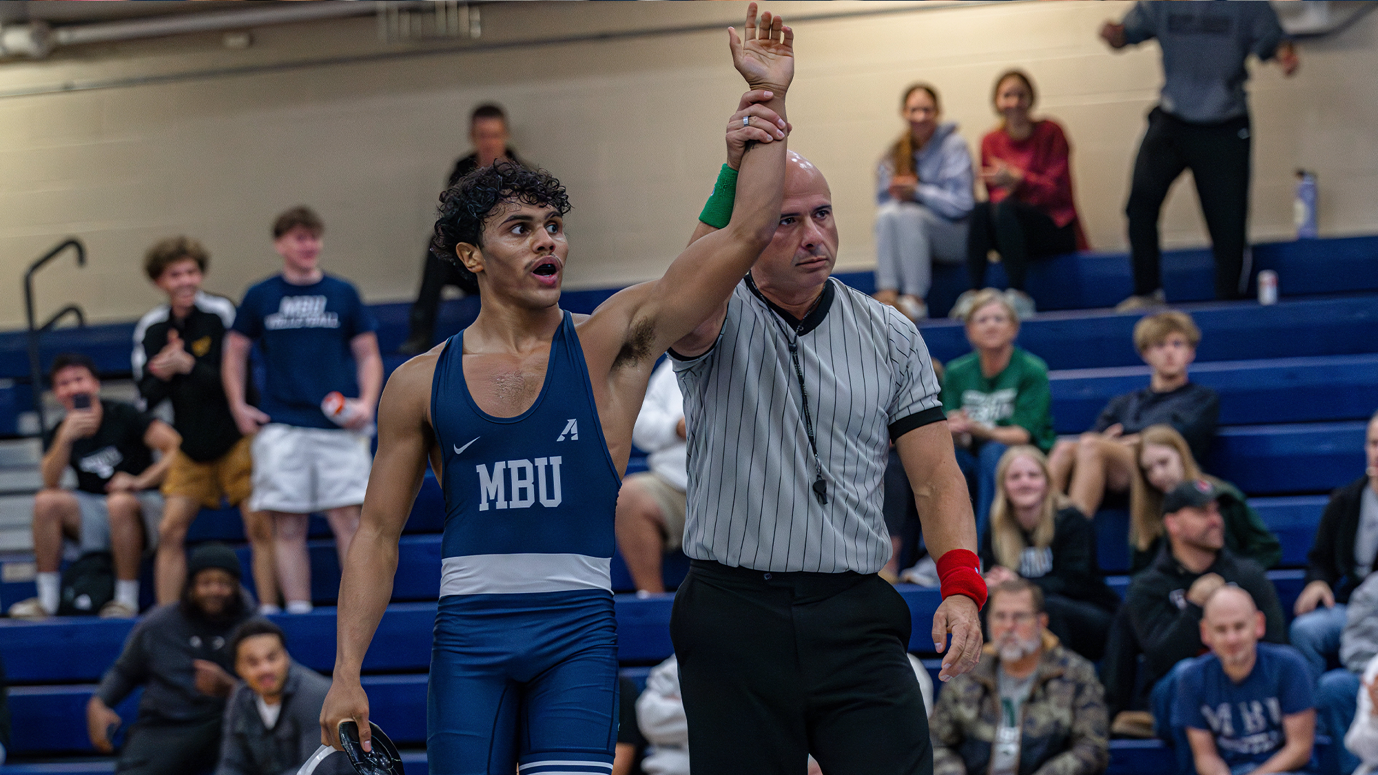 Daryl Mills gets hand raised after beating ranked wrestler from Central Methodist in overtime