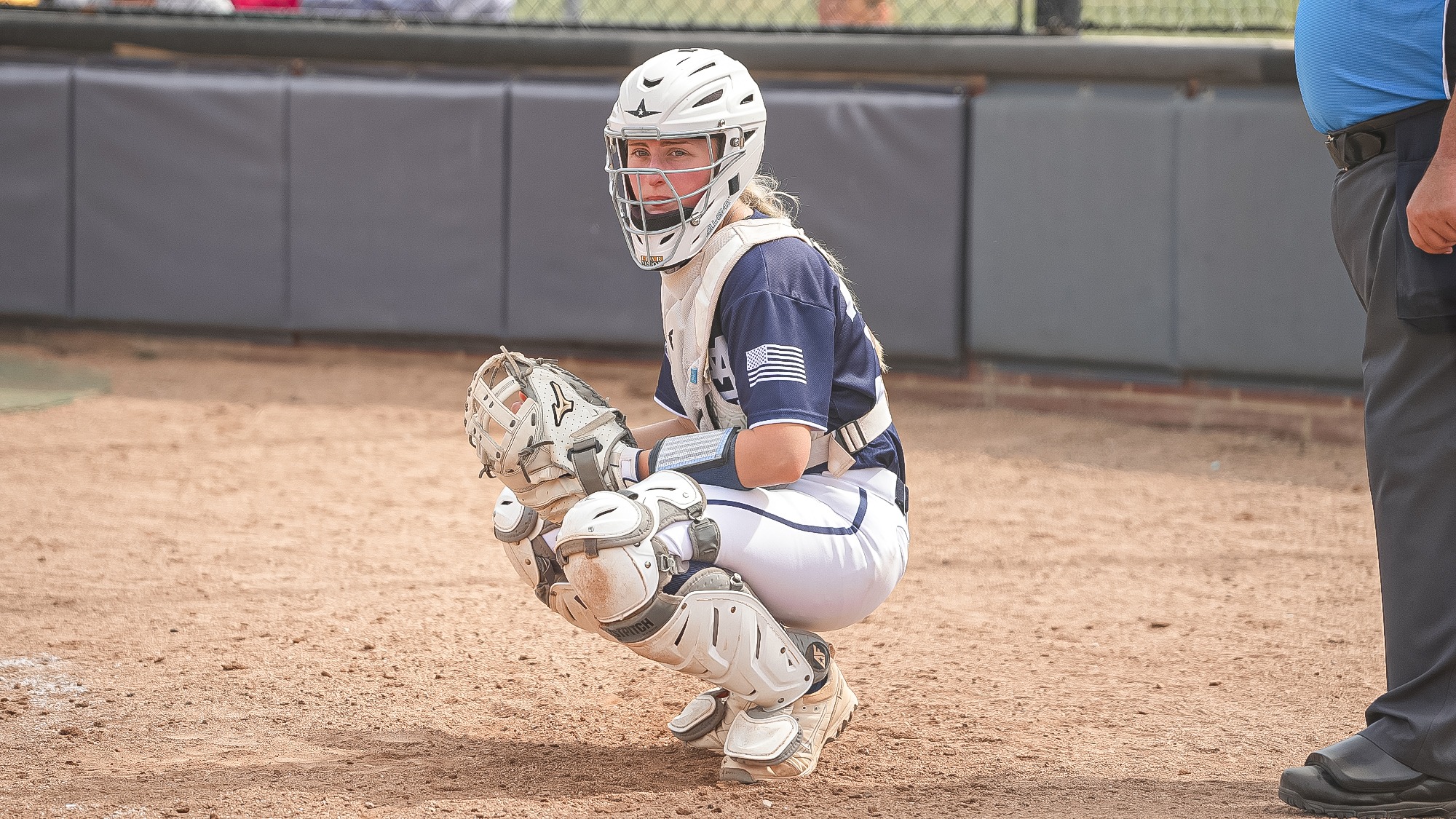 Emily Wright checks in the dugout for a sign (2025)