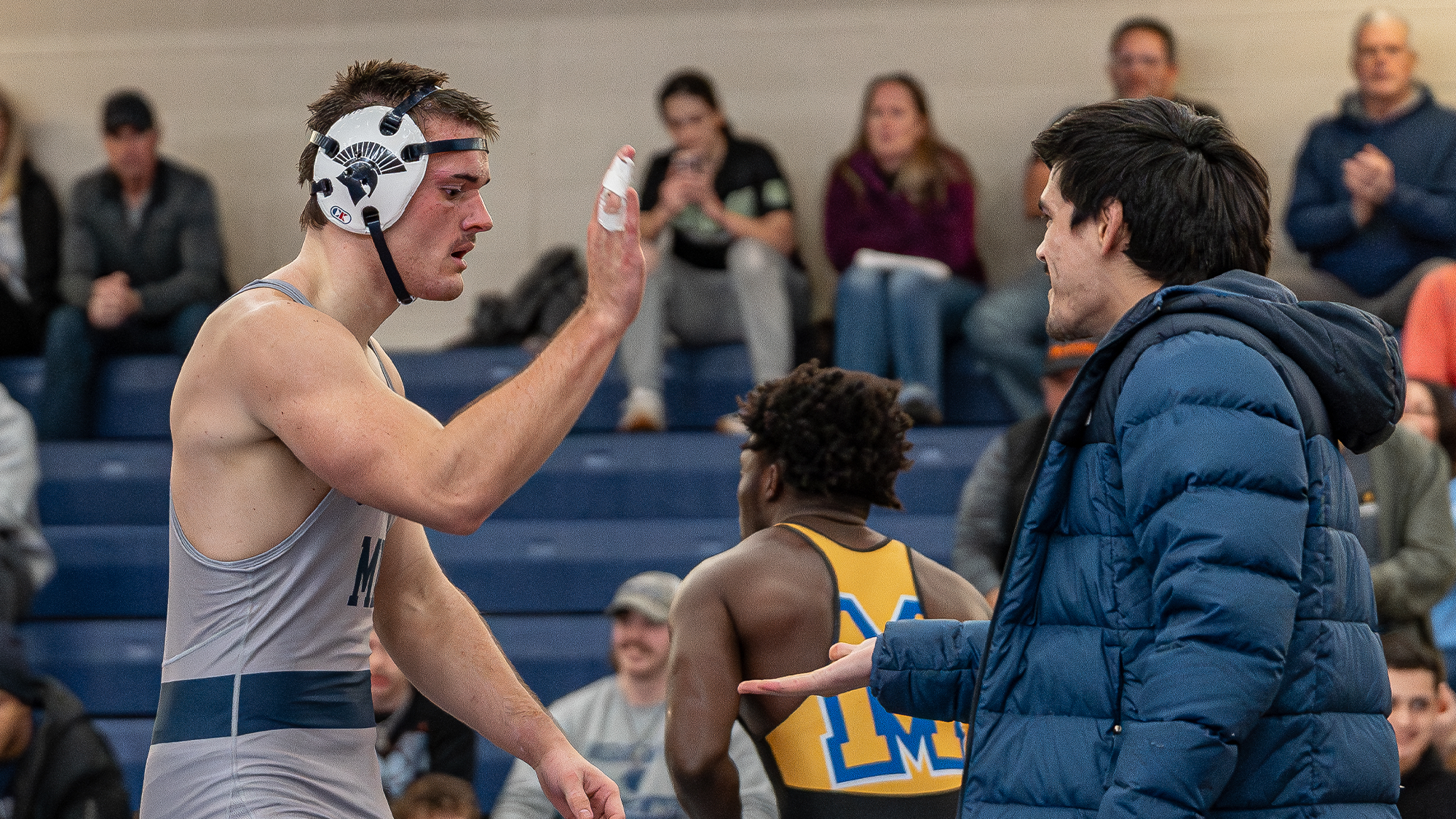 Stotts high-fives assistant coach Tyler Deen after Major decision win over Midway (Ky.)