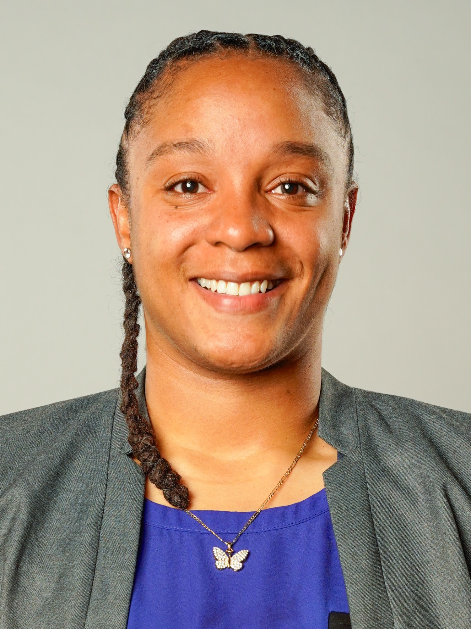 Anjale Barrett (head and shoulders mug shot in a blue shirt and dark colored jacket)