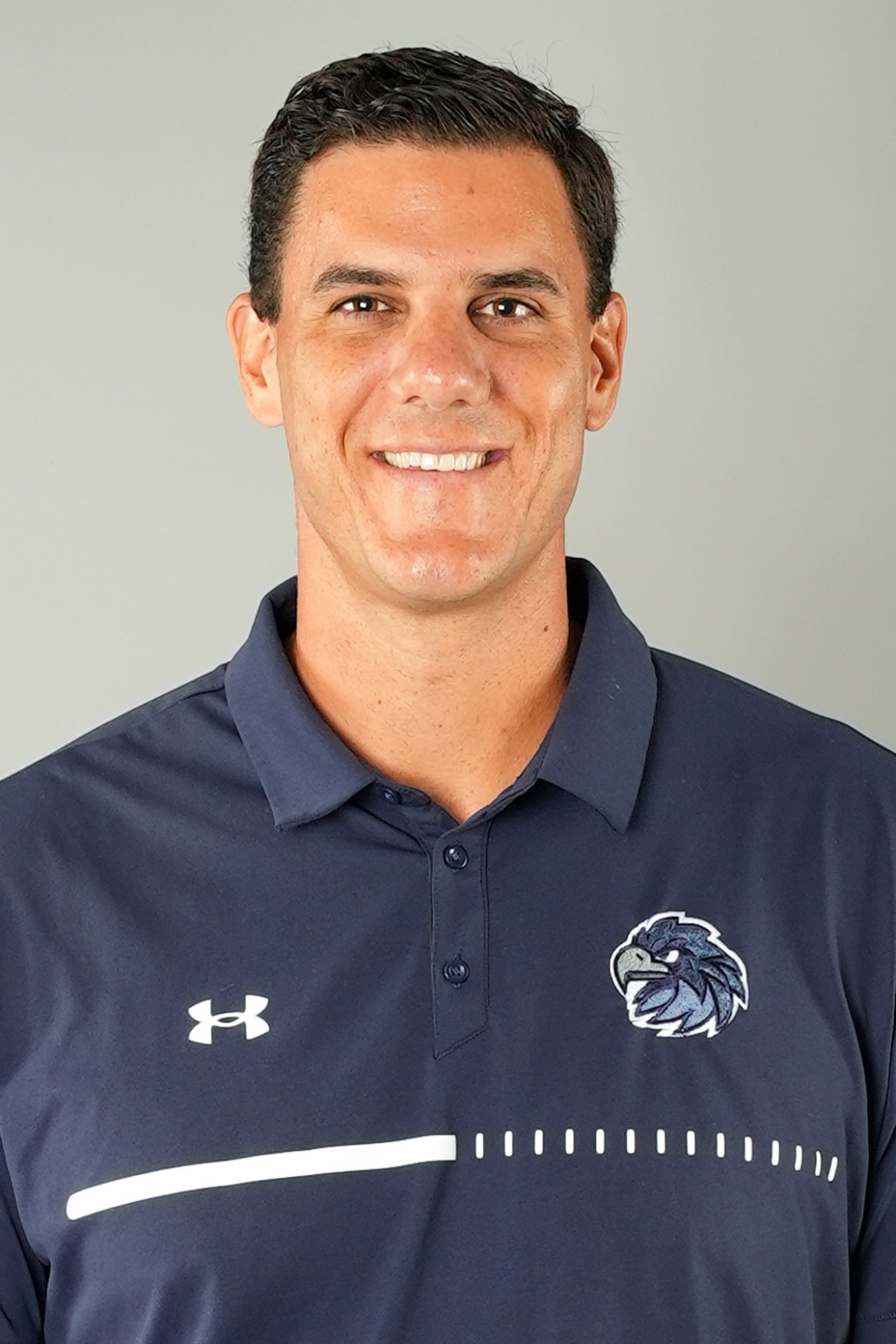 Mike Russo (Head and shoulders mug shot in a blue polo shirt with a Hawk head logo)